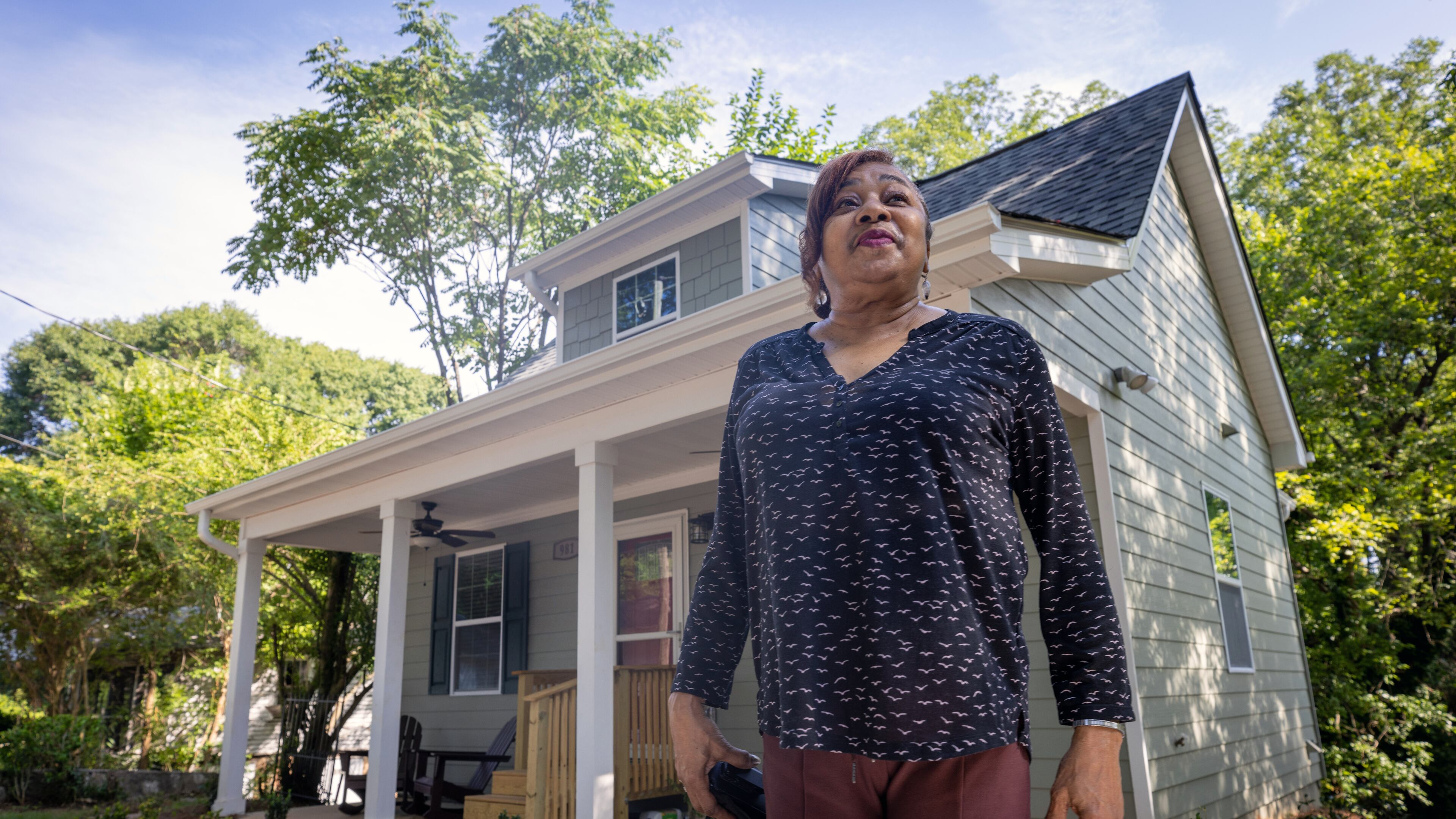 Deborah Glover stands in front of the new home that she will share with young women and children in need of temporary housing. (Steve Schaefer / steve.schaefer@ajc.com)