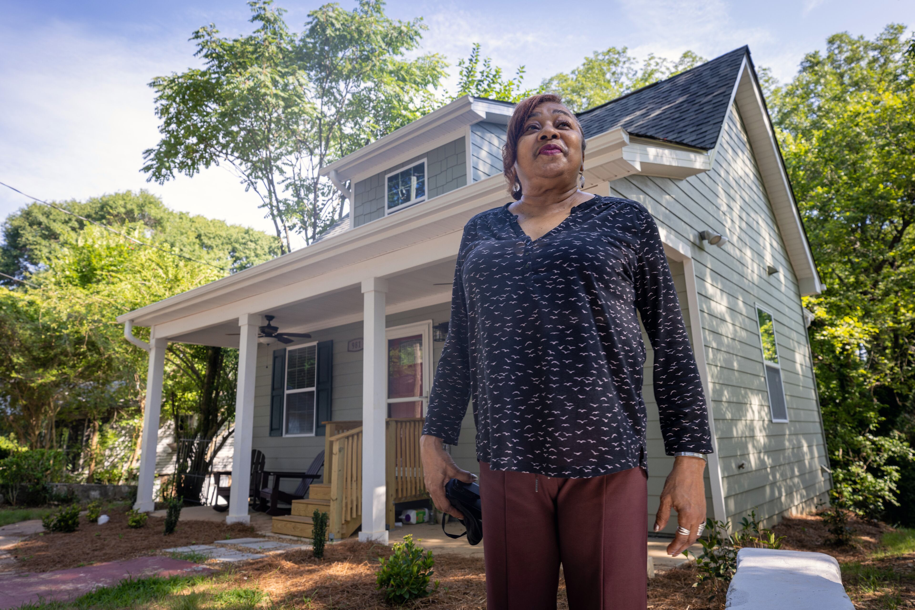 Deborah Glover poses for a photo in front of her new home that she will share with young women and children in need of temporary housing on Friday, July 7, 2022. Steve Schaefer / steve.schaefer@ajc.com)