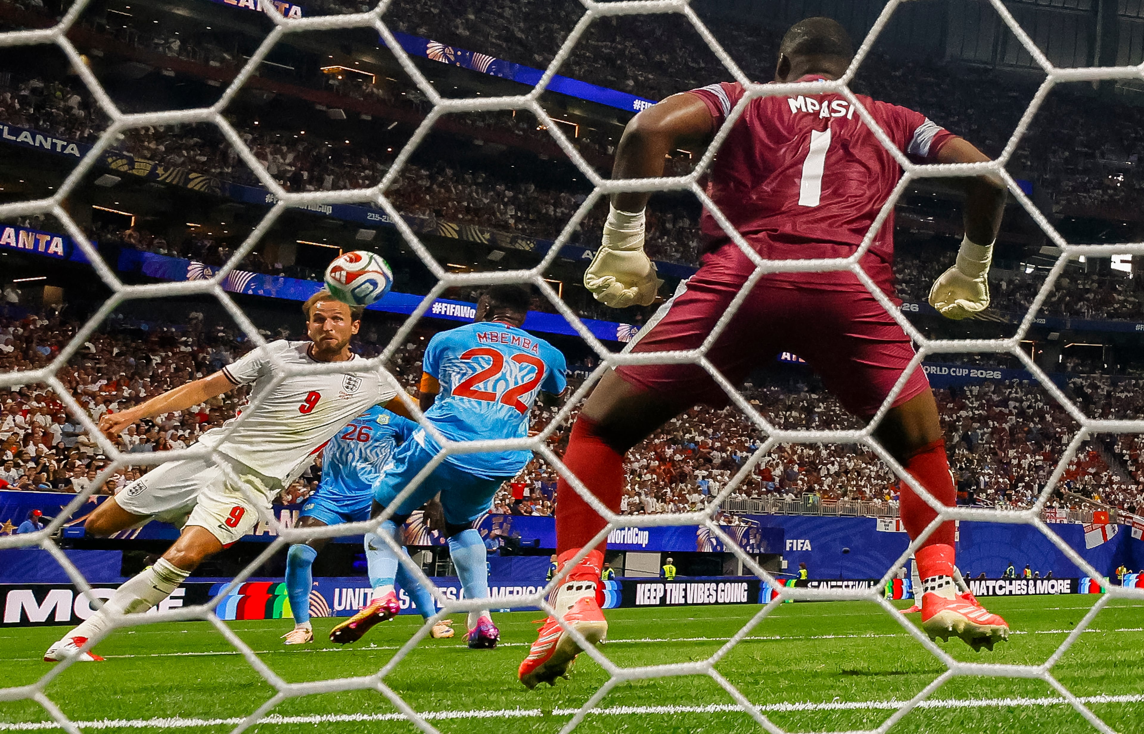 England forward Harry Kane (9) scores a goal against Congo goalkeeper Lionel Mpasi (1) as defender Chancel Mbemba (22) is unable to block him during the second half of a FIFA World Cup round of 32 match at Atlanta Stadium (Mercedes-Benz Stadium) on Wednesday, July 1, 2026, in Atlanta. (Miguel Martinez/AJC)