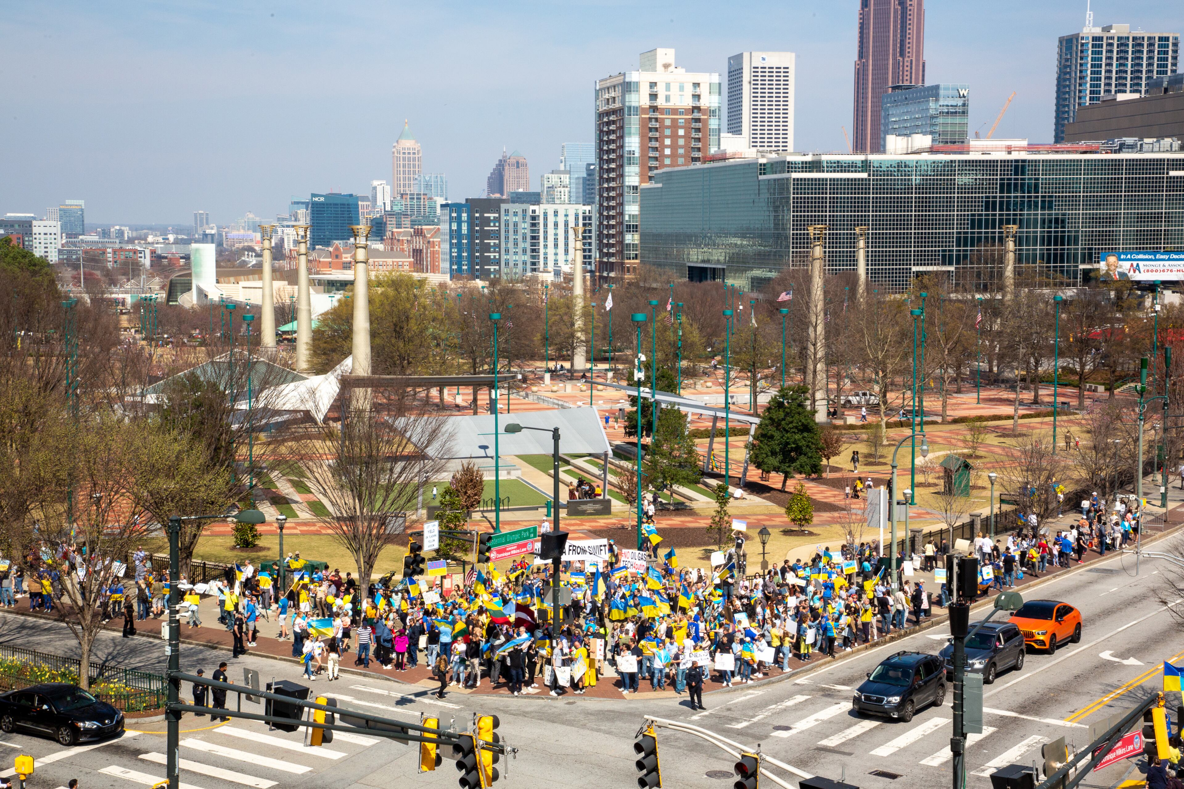 A crowd gathers near the CNN Center outside Centennial Olympic Park during a rally organized by the Ukrainian Community of Atlanta on Saturday, March 5, 2022. (Photo by Steve Schaefer for The Atlanta Journal-Constitution)