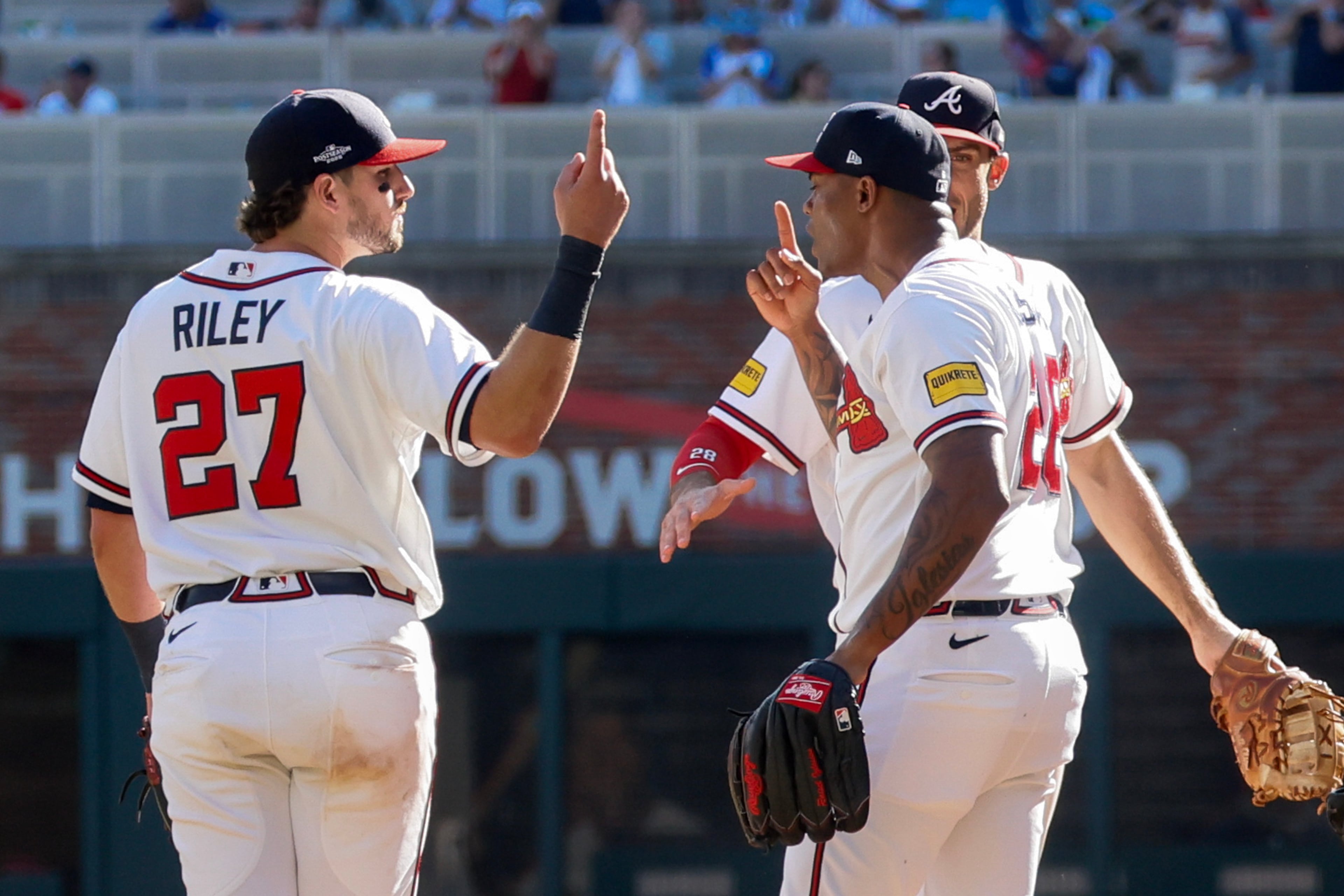 Atlanta Braves pitcher Raisel Iglesias, right, celebrates with third baseman Austin Riley (27) after closing out the Philadelphia Phillies during the ninth inning of Game 1 of a MLB National League Wild Card playoff series between the Atlanta Braves and the Philadelphia Phillies, Tuesday, Sept. 29, 2026, in Atlanta. (Miguel Martinez/AJC)