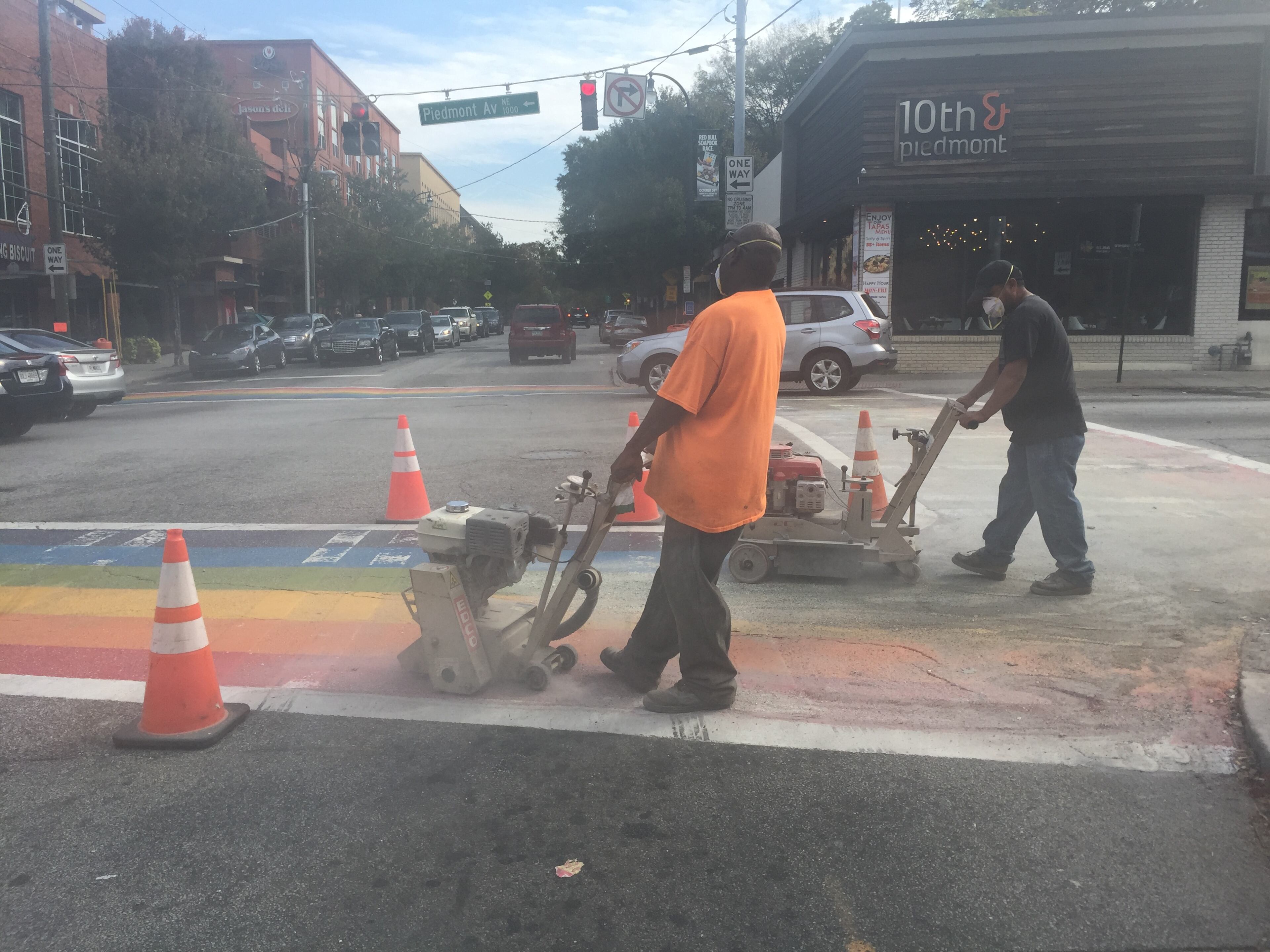 Construction crews on the intersection of 10th and Piedmont in Midtown erase the four rainbow crosswalks installed for Atlanta Pride on Saturday, October 24, 2015.