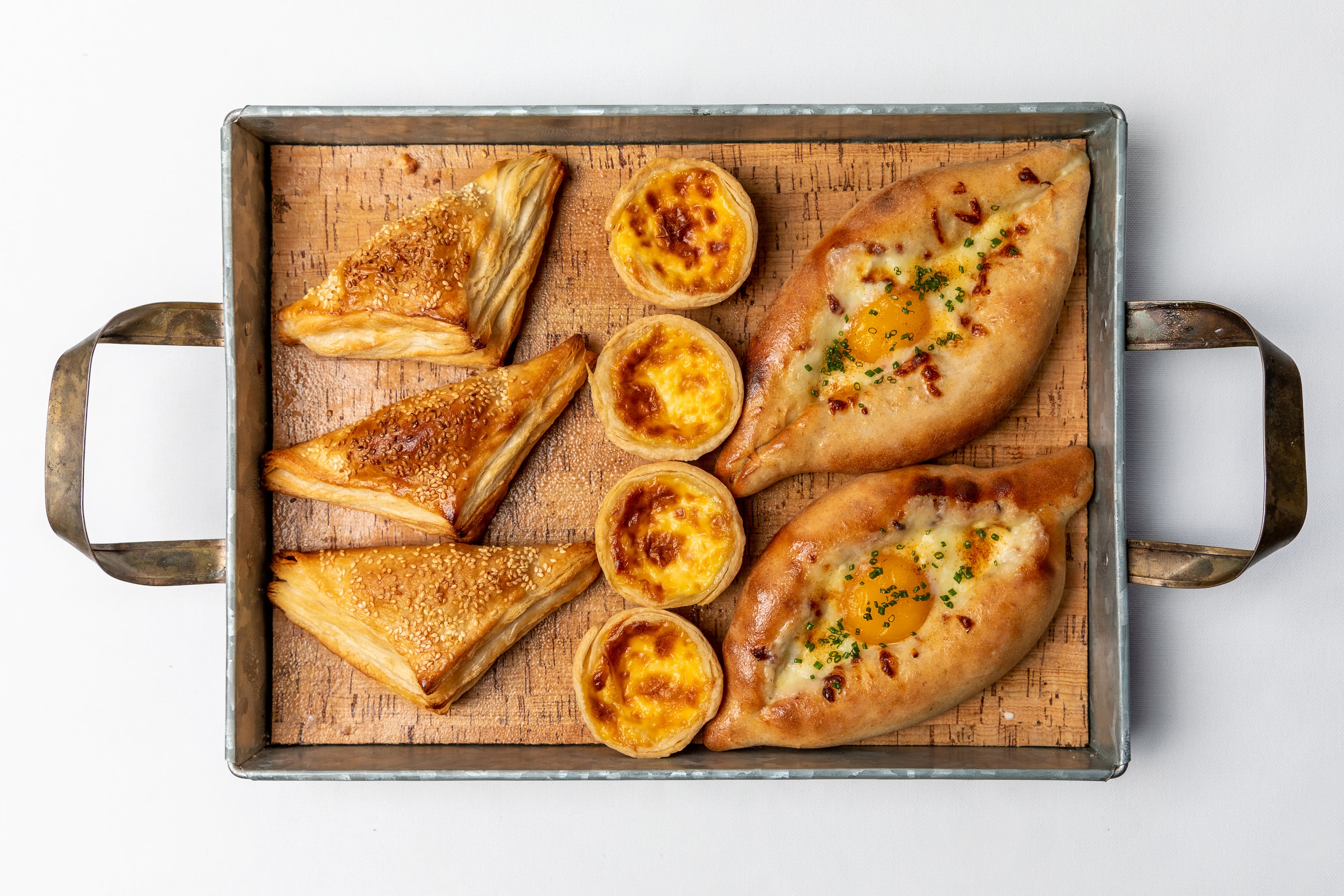 Spinach Turnover, Egg Tarts and Georgian Egg Bread from Juniper Cafe. / Photo by Eric Sun