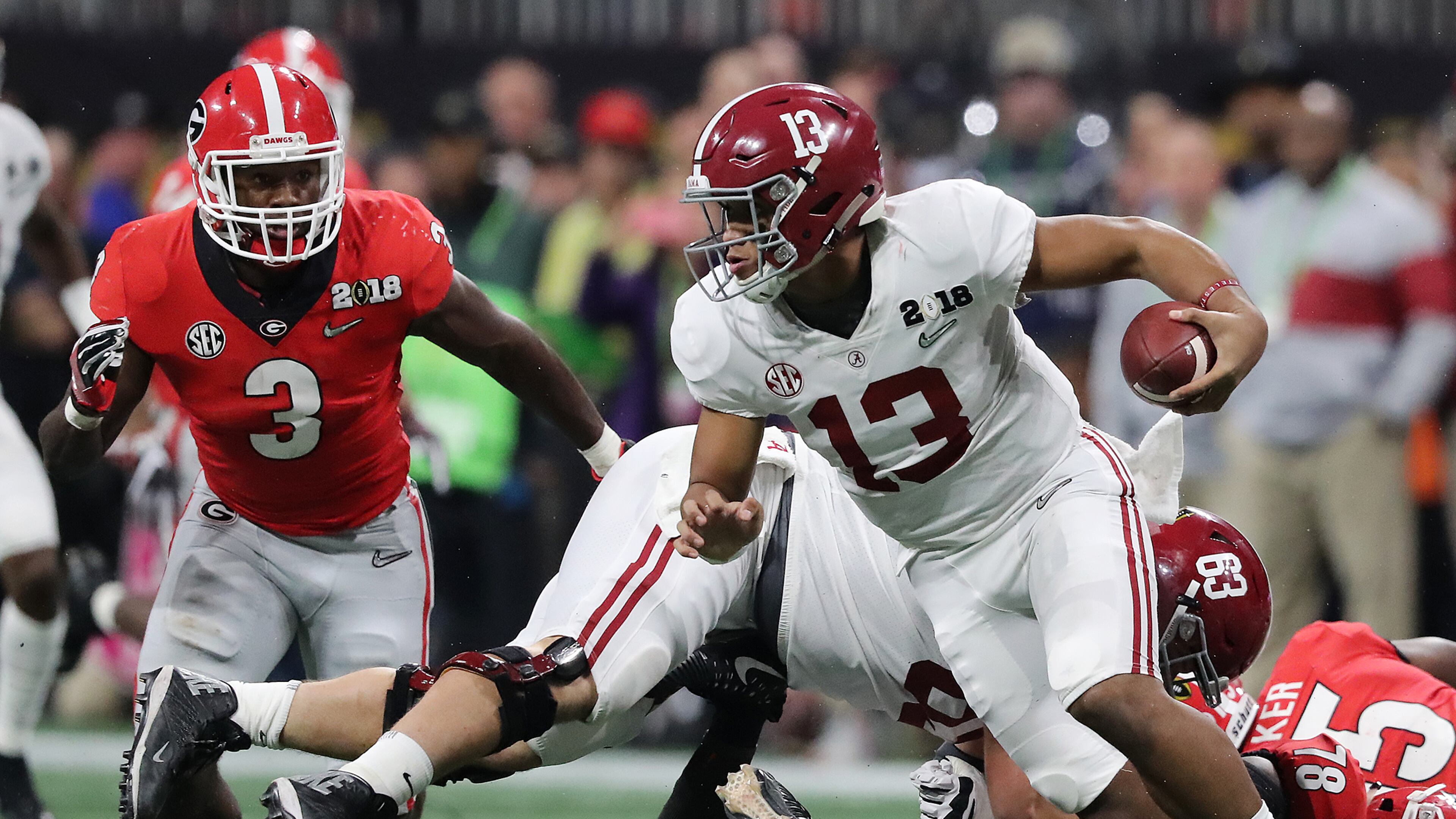 Alabama quarterback Tua Tagovailoa eludes the Georgia pass rush during the third quarter of the national championship. (Curtis Compton/ccompton@ajc.com)