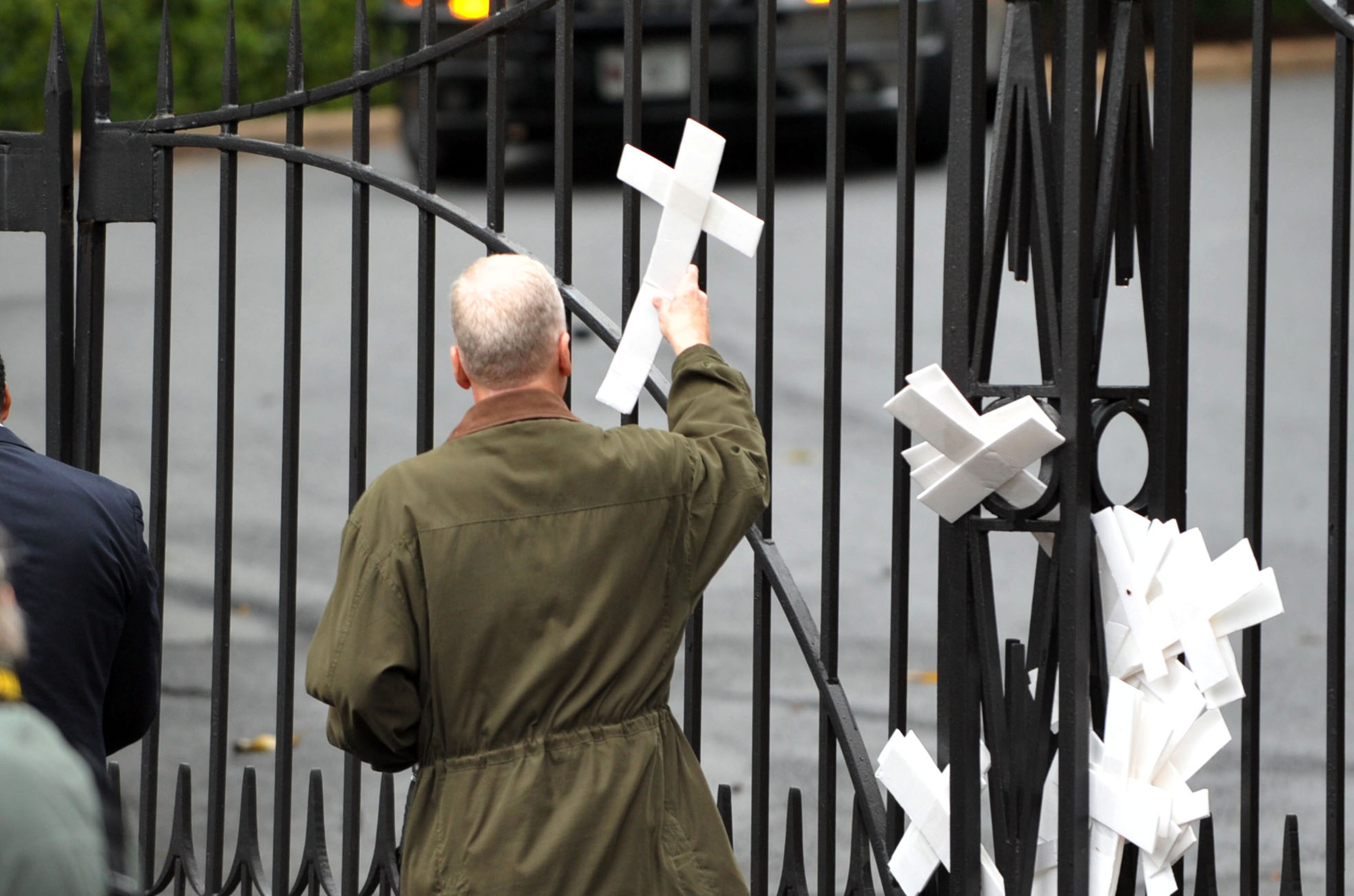 Protesters, who could not get inside the gates to the Governor's Mansion, left crosses before departing.KENT D. JOHNSON / KDJOHNSON@AJC.COM