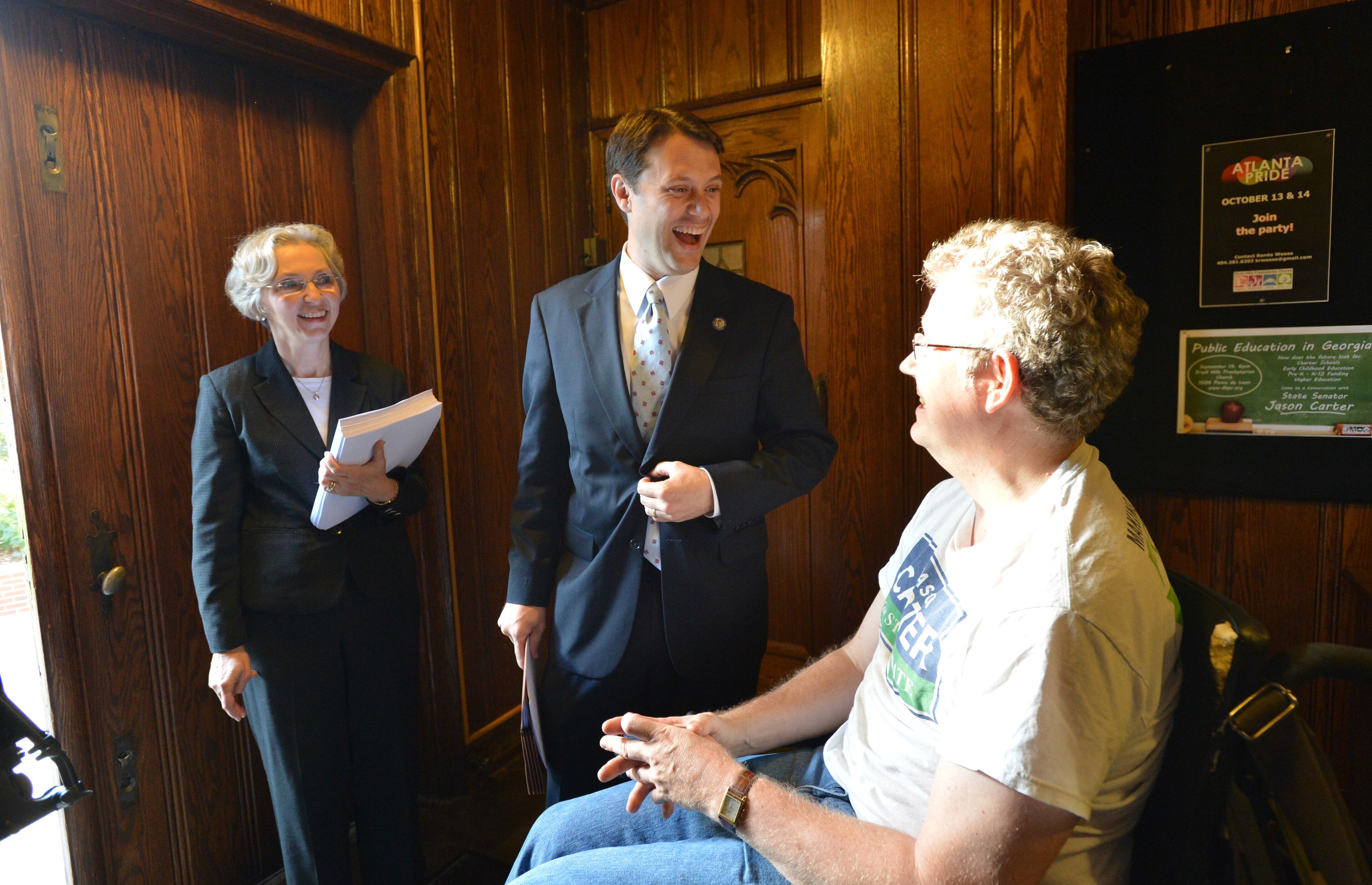 Georgia state Sen. Jason Carter (center) is greeted by his supporter Jon Houghton (right), of Atlanta as Jane Fahey (left), pastor of Druid Hills Presbyterian Church, looks on before Georgia Public Education Forum at Druid Hills Presbyterian Church in Atlanta on Sept. 19, 2012.