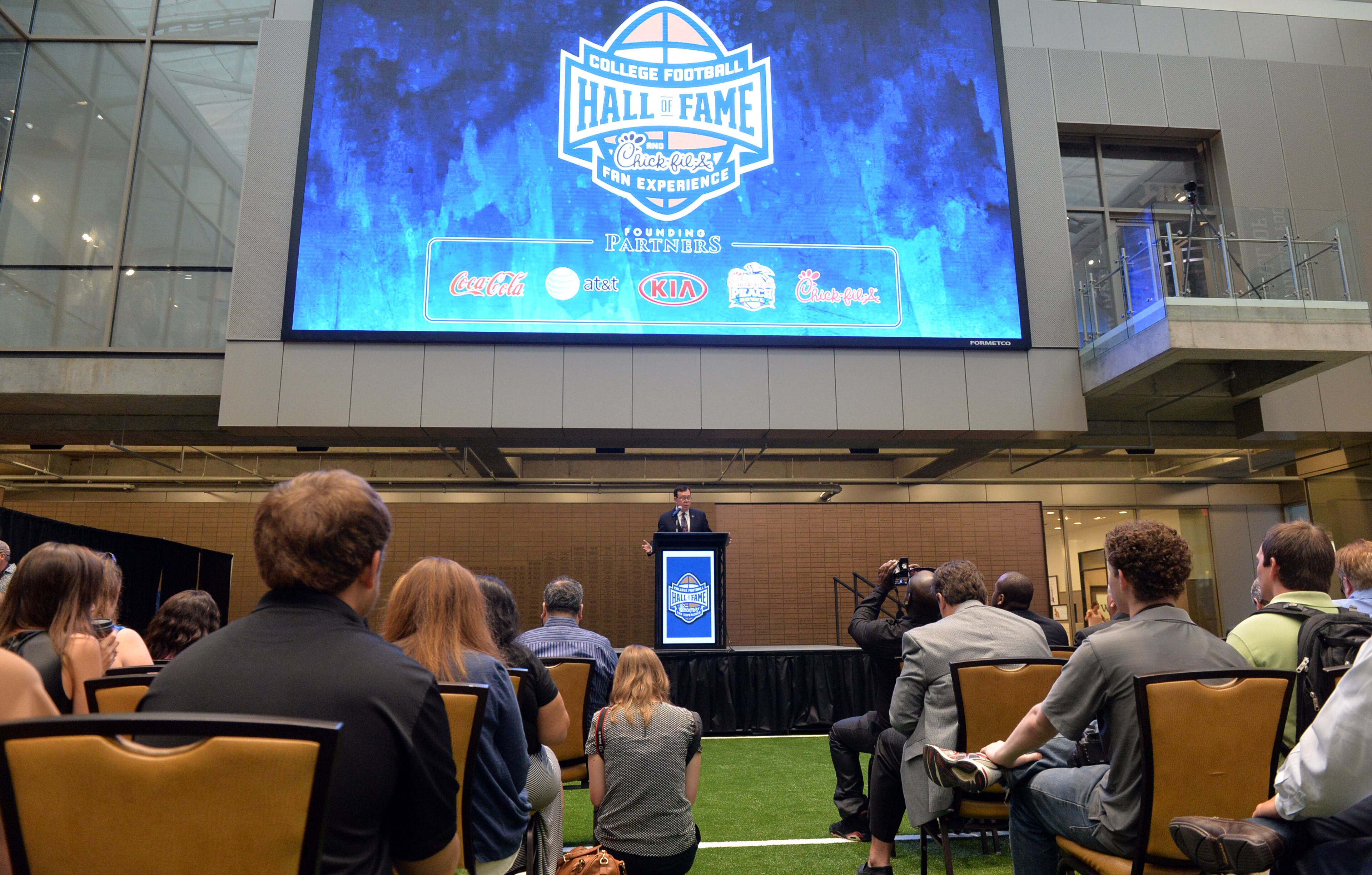 Sportscaster Tony Barnhart "the voice of college football" makes introductions during the event, a press conference and media day at the College Football Hall of Fame on Wednesday, August 20, 2014. Ten college football greats are expected to be on hand for the museum's opening day.