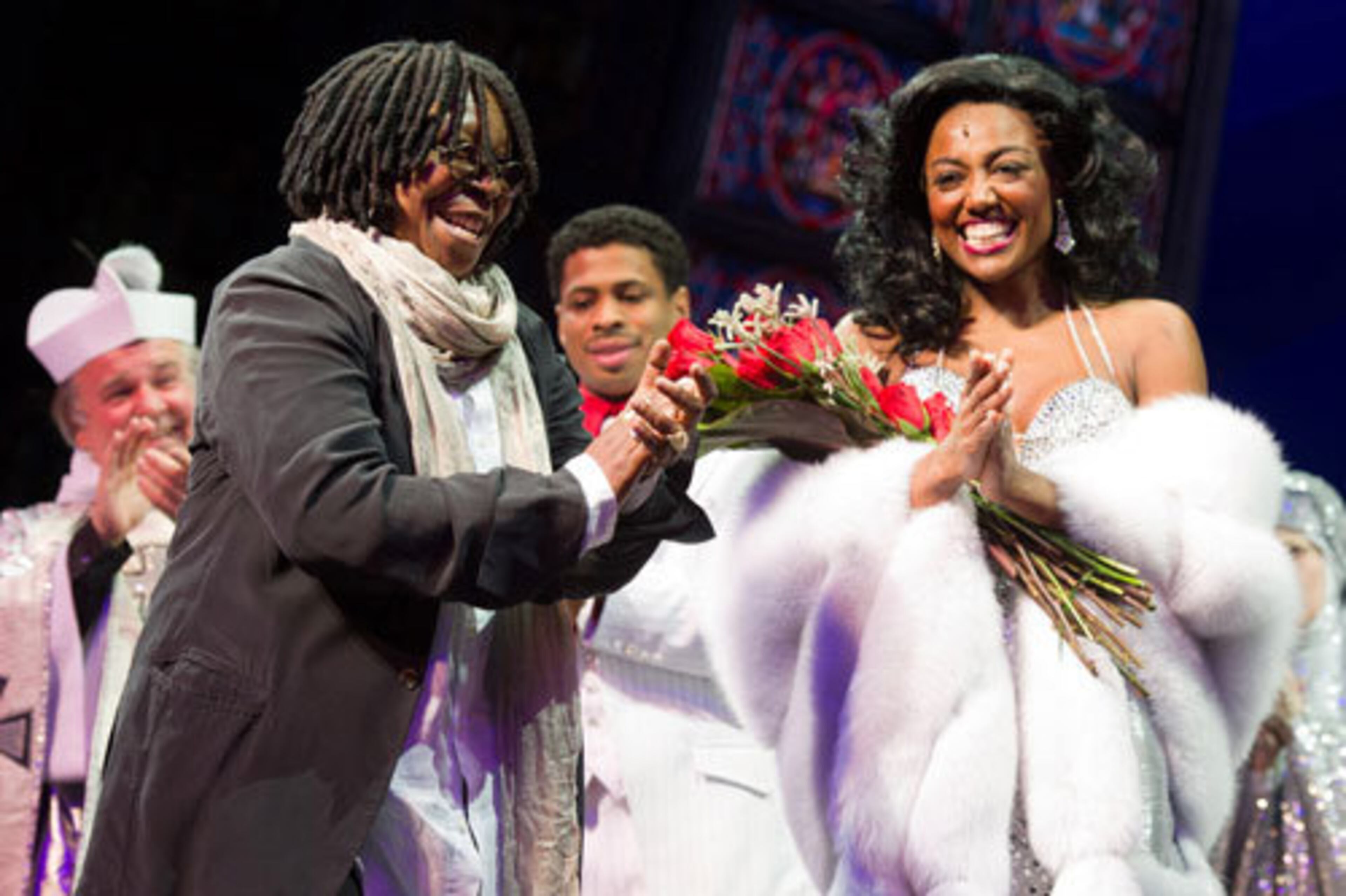 Whoopi Goldberg applauds Patina Miller and the other cast members on stage.