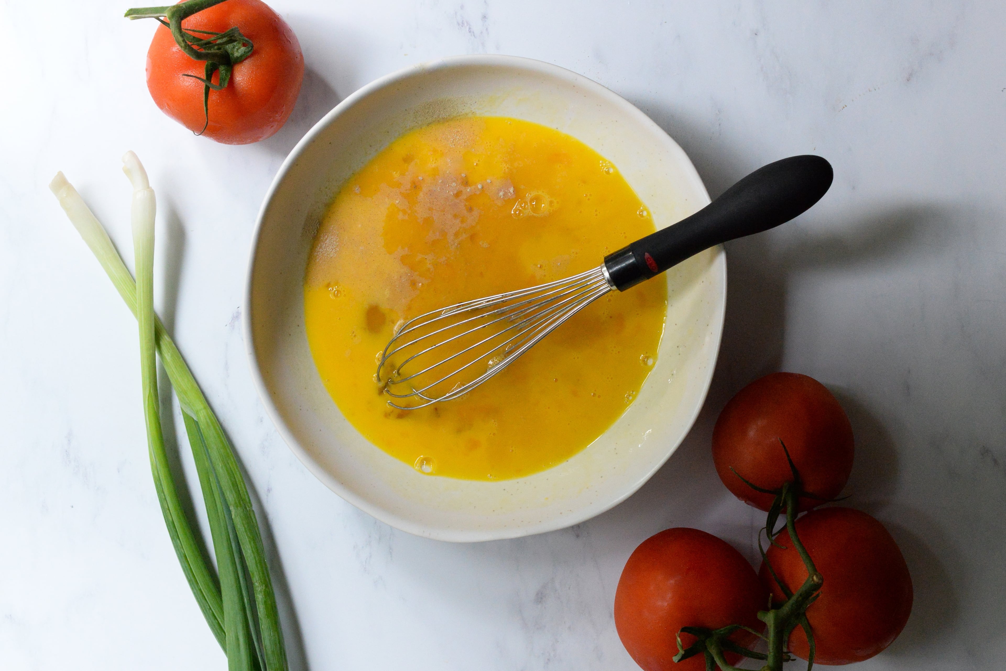 In a bowl, whisk together eggs, sesame oil and salt. In a second bowl, combine chicken broth, cornstarch, chicken powder, and optional sugar and white pepper if desired. Stir the chicken broth mixture well. (Candy Hom for the AJC)