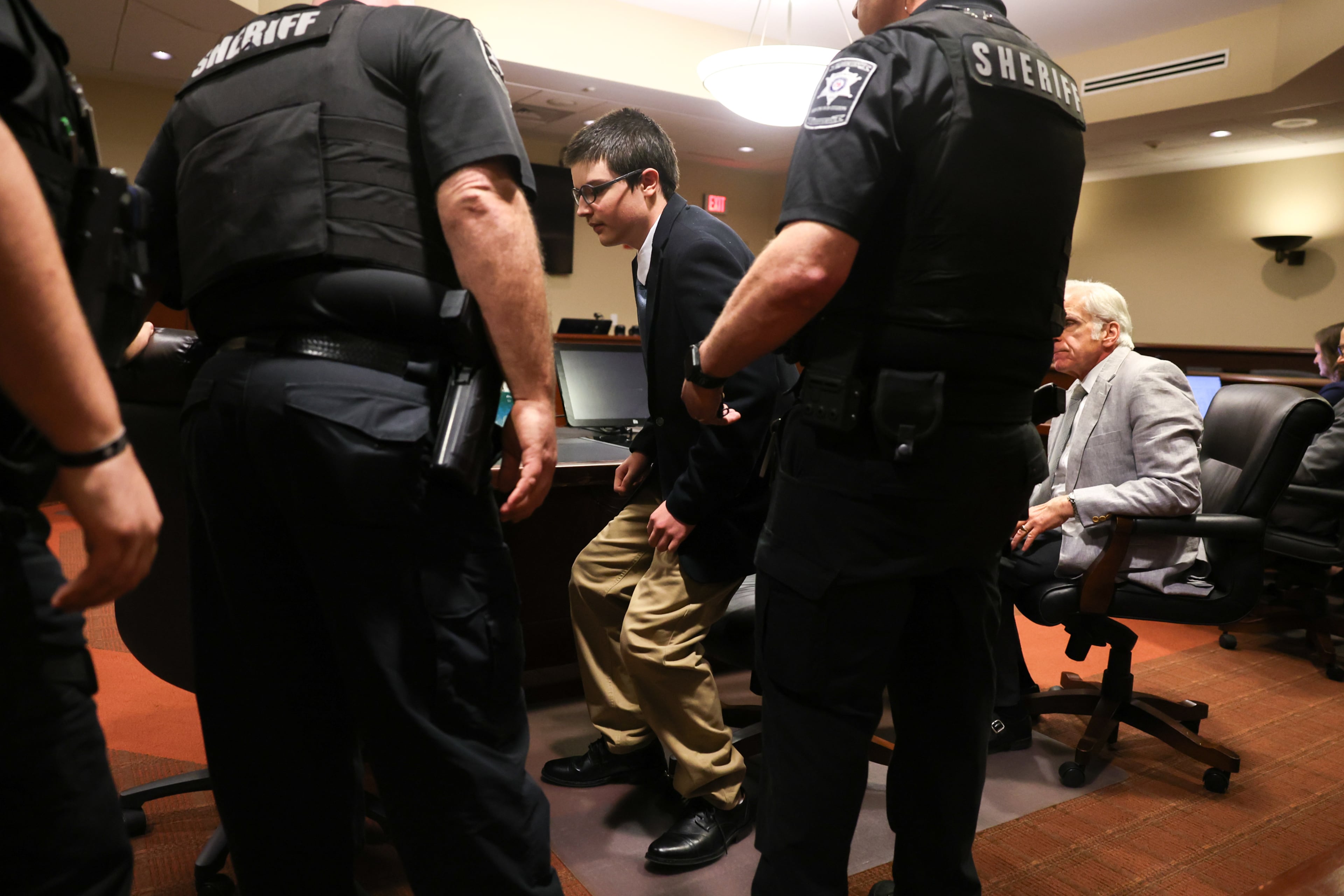 Colt Gray, the 16-year-old Apalachee High School shooting suspect, stands to be handcuffed following his sentencing at Barrow County Superior Court in Winder on July 28, 2026. He received life without parole for killing two students and two teachers. (Arvin Temkar/AJC)