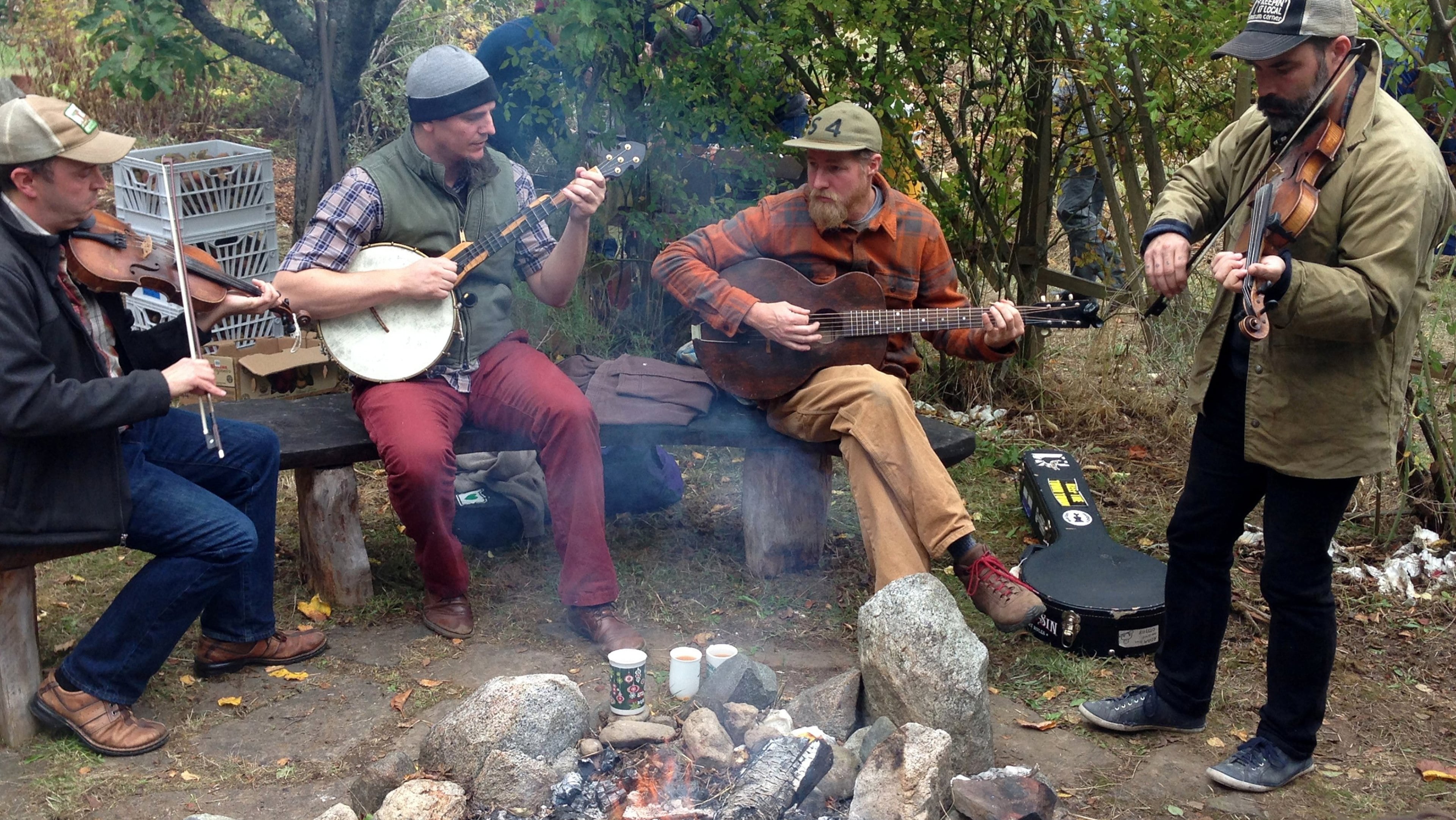In an orchard at Fruit City Farms on Lopez Island, musicians entertain around a bonfire during an Octoer 2017 farm tour. (Brian J. Cantwell /Seattle Times/TNS)
