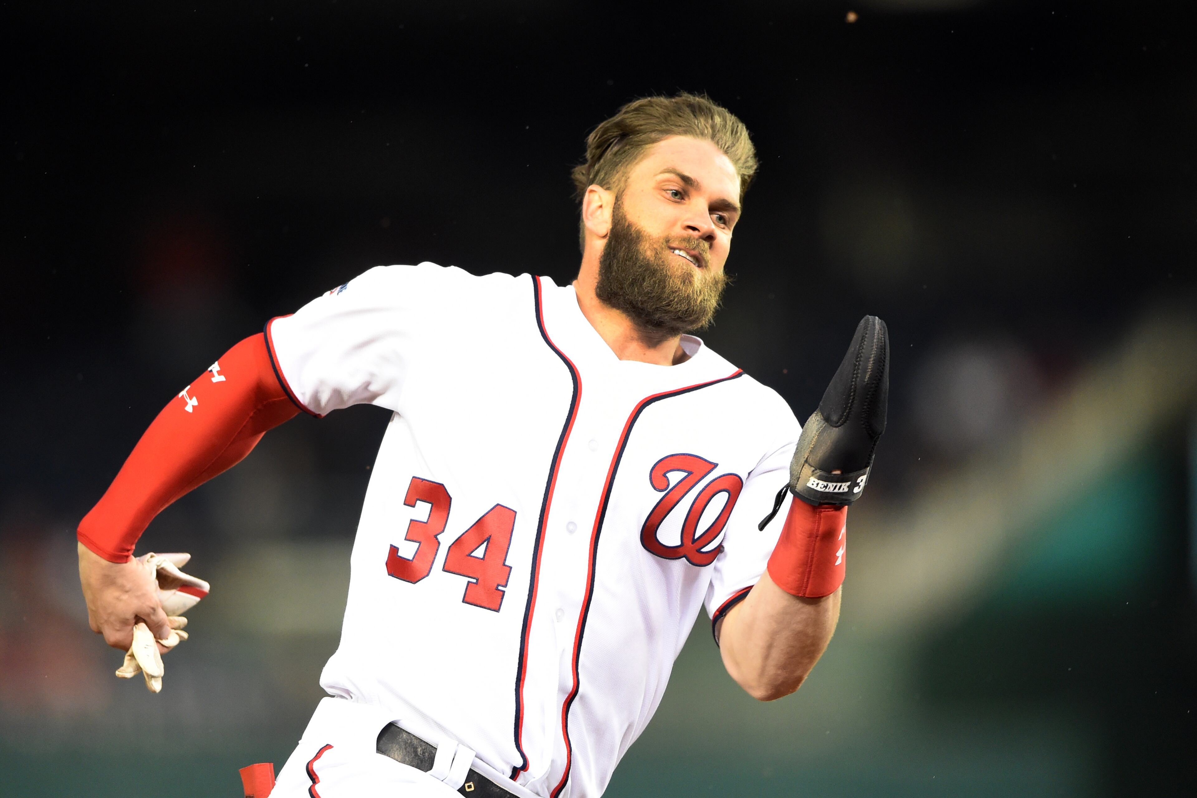 Bryce Harper rounds third and scores on Howie Kendrick's hit during the first inning. (Photo by Mitchell Layton/Getty Images)