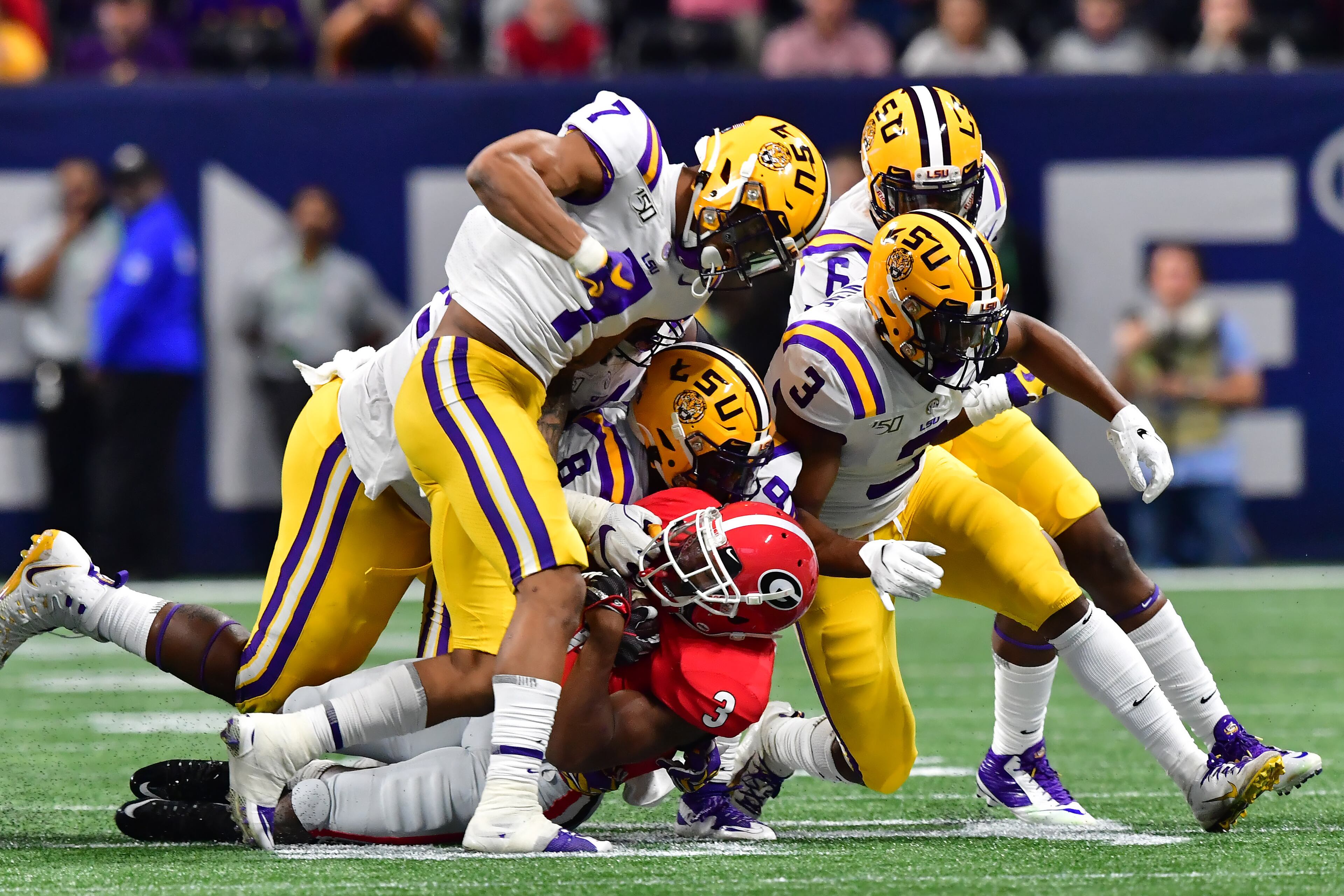Georgia Bulldogs running back Zamir White (3) is smothered by LSU Tigers defenders during the first half of the Georgia vs. LSU SEC Football Championship game at Mercedes-Benz Stadium in Atlanta. Hyosub Shin / hyosub.shin@ajc.com