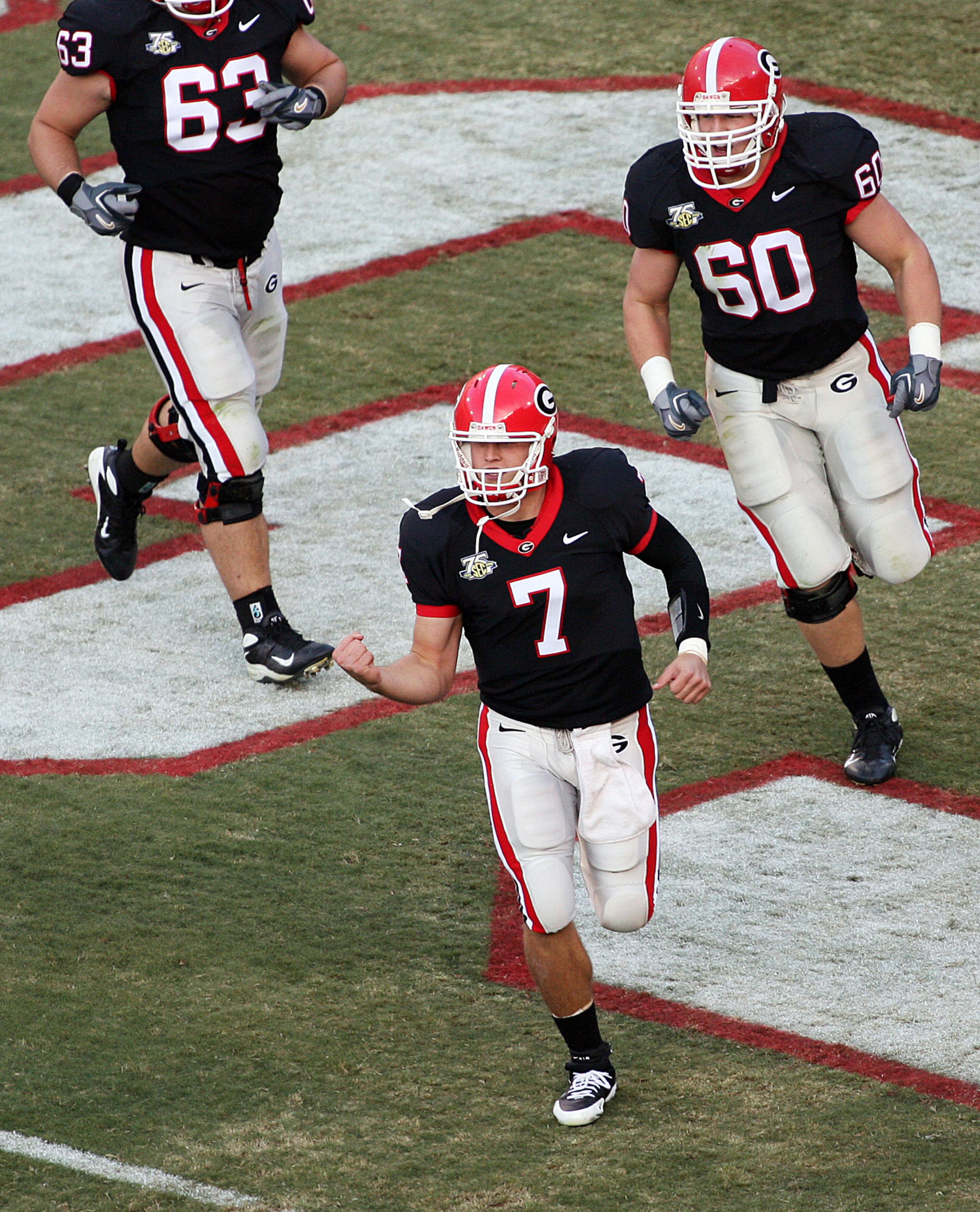 Georgia quarterback Matthew Stafford (7) and offensive lineman Clint Boling (60) run off the field celebrating after their first touchdown of the day in a win over Auburn on November 10, 2007 in Athens. POUYA DIANAT / AJC Staff