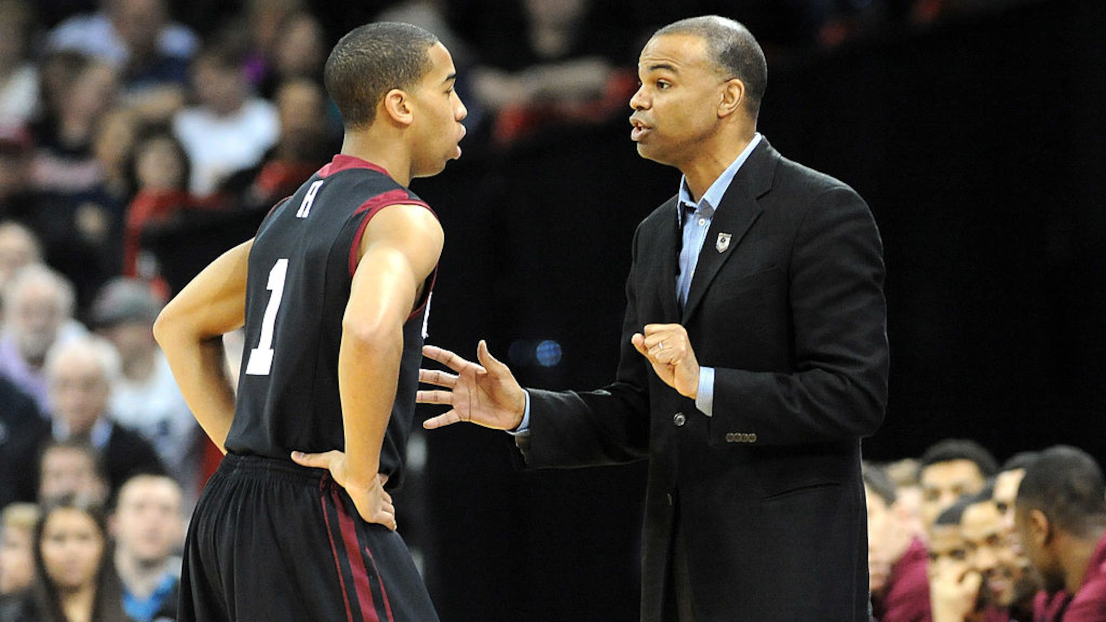 SPOKANE, WA - MARCH 20: Head coach Tommy Amaker of the Harvard Crimson talks to Siyani Chambers #1 of the Harvard Crimson during their game against the Cincinnati Bearcats in the second round of the 2014 NCAA Men's Basketball Tournament at Spokane Veterans Memorial Arena on March 20, 2014 in Spokane, Washington. (Photo by Steve Dykes/Getty Images)