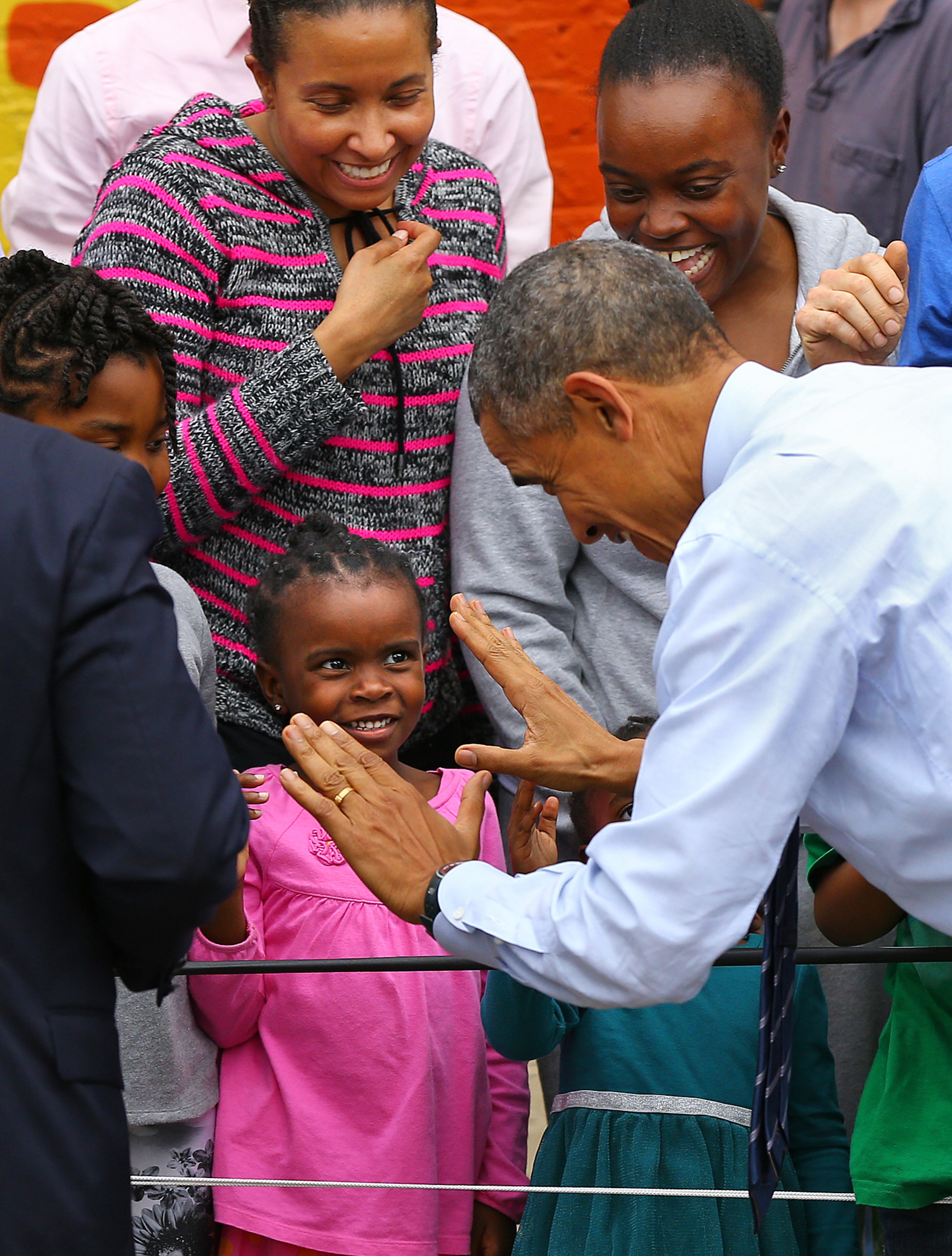 President Barack Obama gives a young girl a double high five as he leaves Manuel's Tavern on Tuesday, March 10, 2015, in Atlanta. Curtis Compton / ccompton@ajc.com