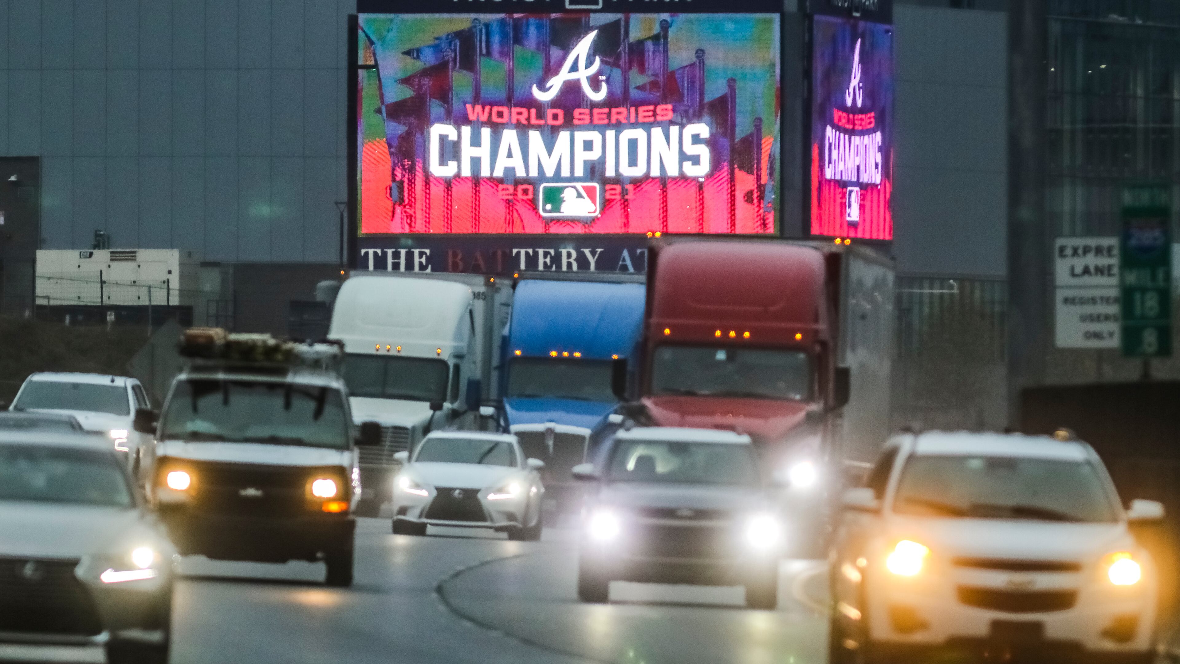 Southbound I-285 traffic passes large digital billboards at Truist Park after the Atlanta Braves clinched the 2021 World Series championship. (John Spink/AJC file)