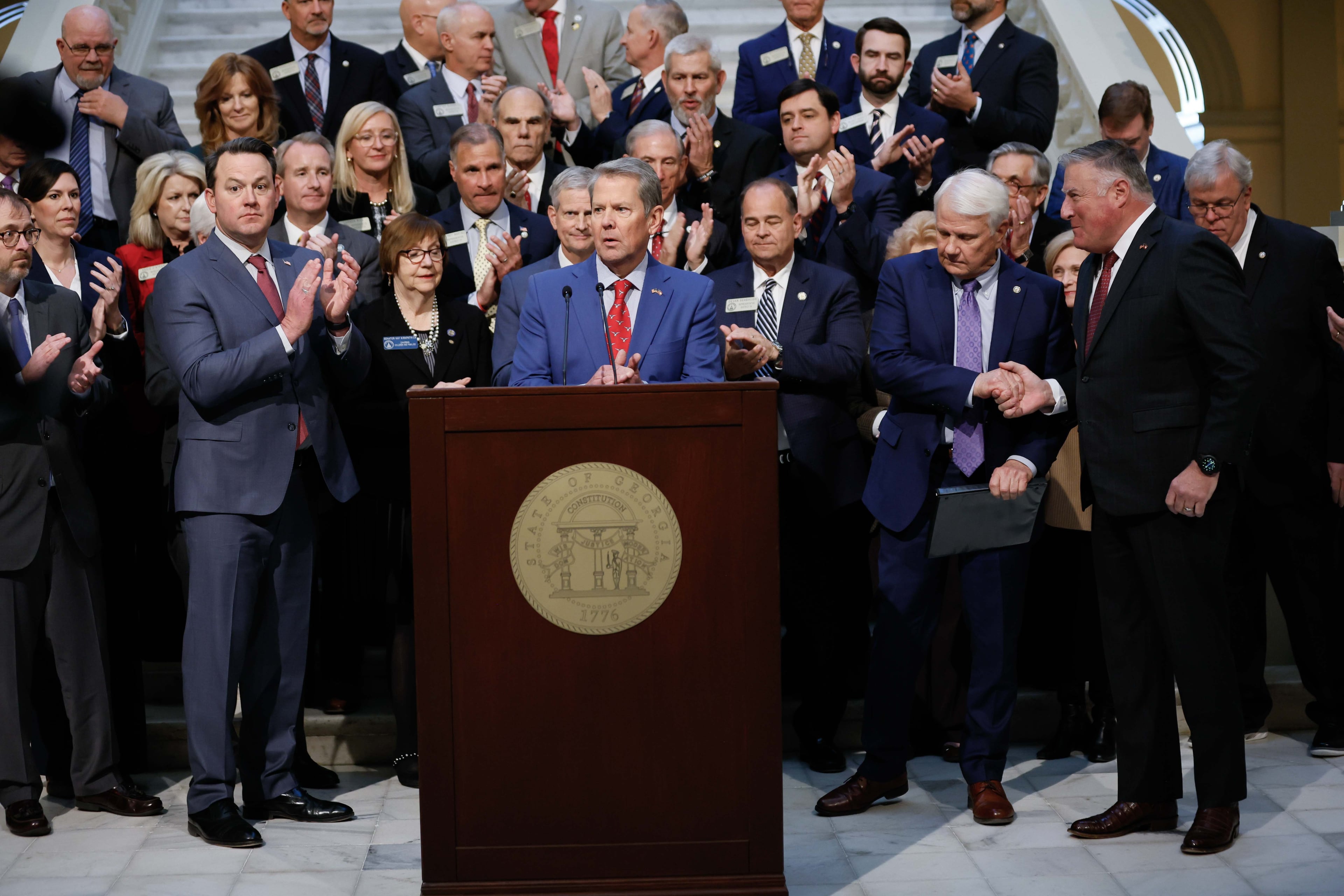 Lt. Gov. Burt Jones (from left), Gov. Brian Kemp, Speaker of the House Jon Burns and Insurance Commissioner John King applaud during a news conference related to Medicaid on Wednesday, Jan. 15, 2025, at the state Capitol in Atlanta. (Miguel Martinez/AJC)