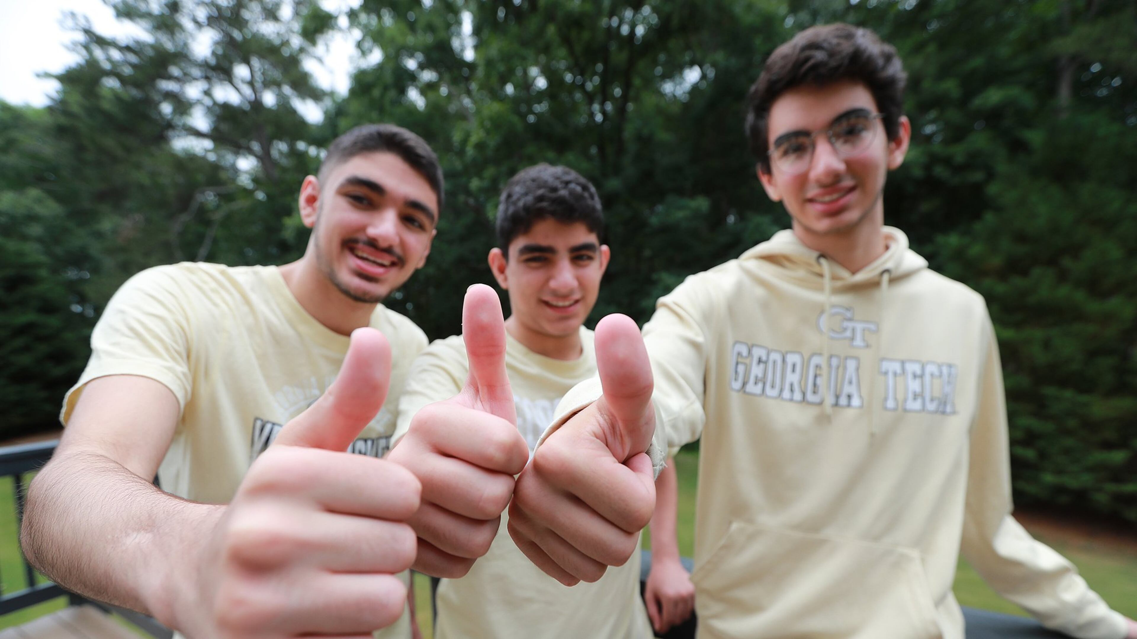 All for one and one for all, the Kashlan triplets Zane (from left), Adam and Rommi are all headed to Georgia Tech, giving the thumbs-up during an interview Tuesday. The brothers were also this year’s valedictorians of West Forsyth High School. CURTIS COMPTON / CCOMPTON@AJC.COM