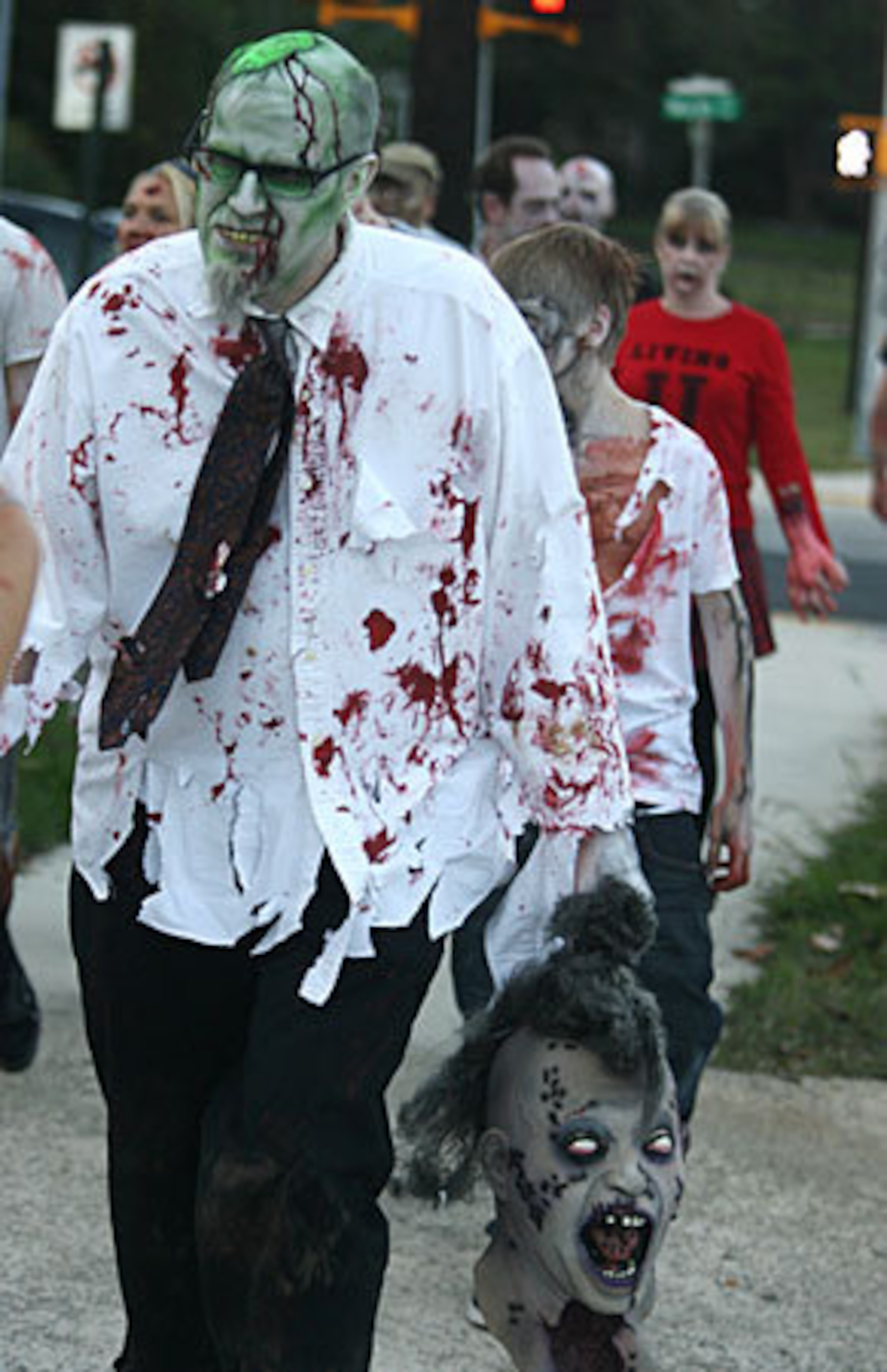 Getting ahead of the Halloween rush, more than 300 people dressed as zombies walked from the Masquerade nightclub to Little Five Points. Dave Cook of Suwanee, head in hand, was among those participating in the annual Zombie Walk that marks the end of the weekend long Atlanta Horrorfest III at Masquerade.