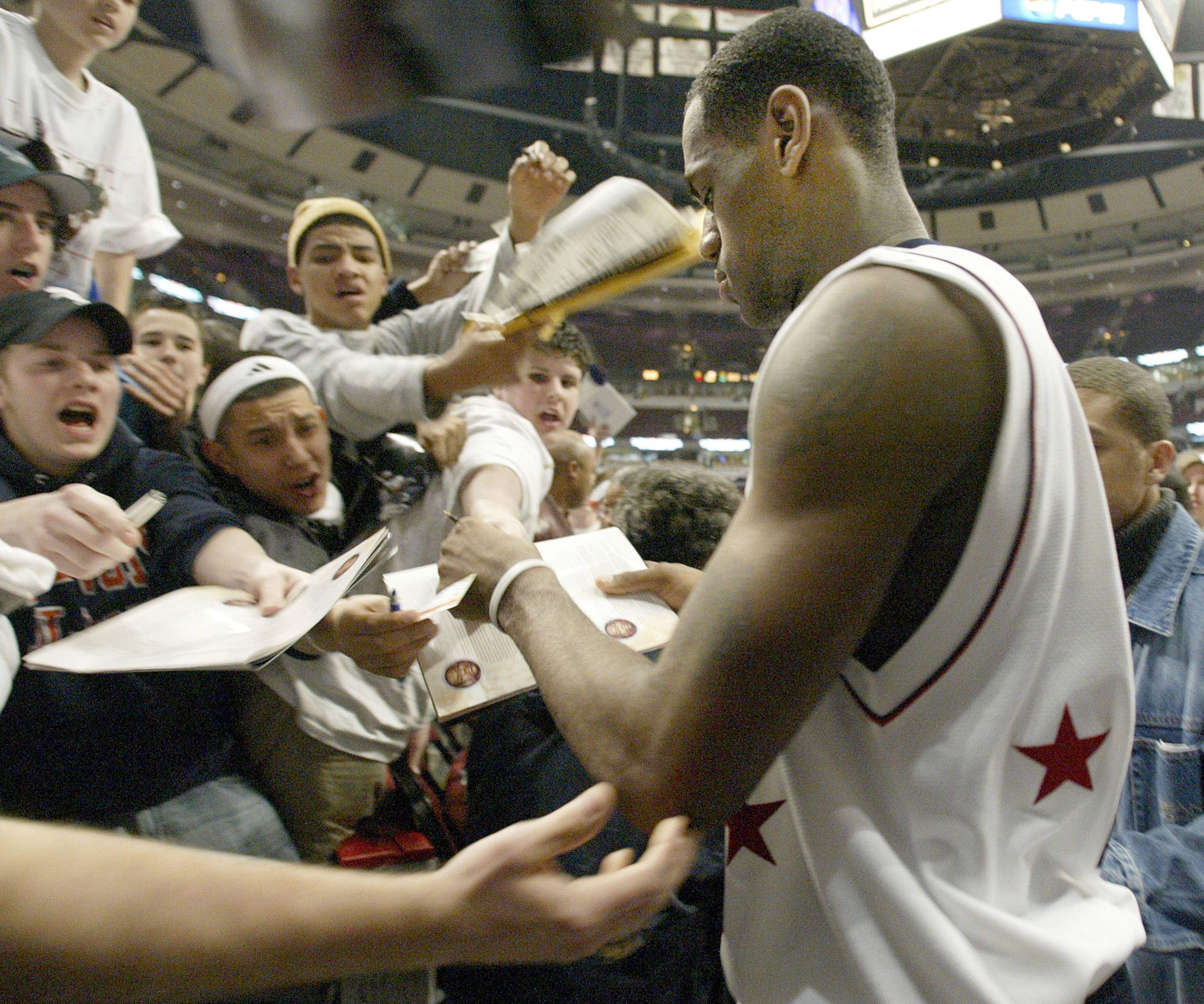 Fans vie for the autograph of high school basketball star LeBron James, of Akron, Ohio, following the EA Sports Roundball Classic in Chicago, Monday, March 31, 2003.