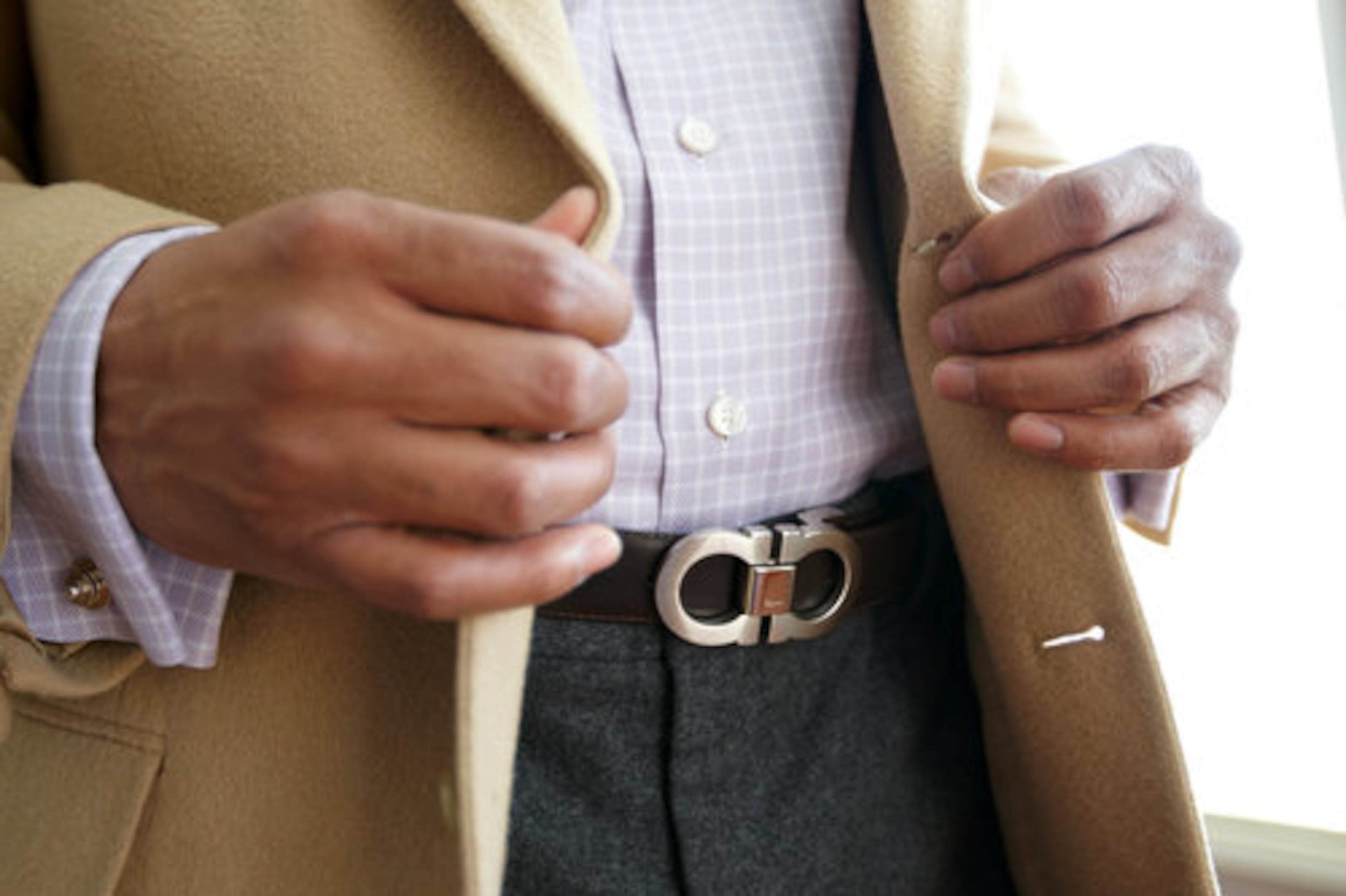 Garth accessorizes his outfit with a Ferragamo belt and Tiffany & Co. cufflinks.