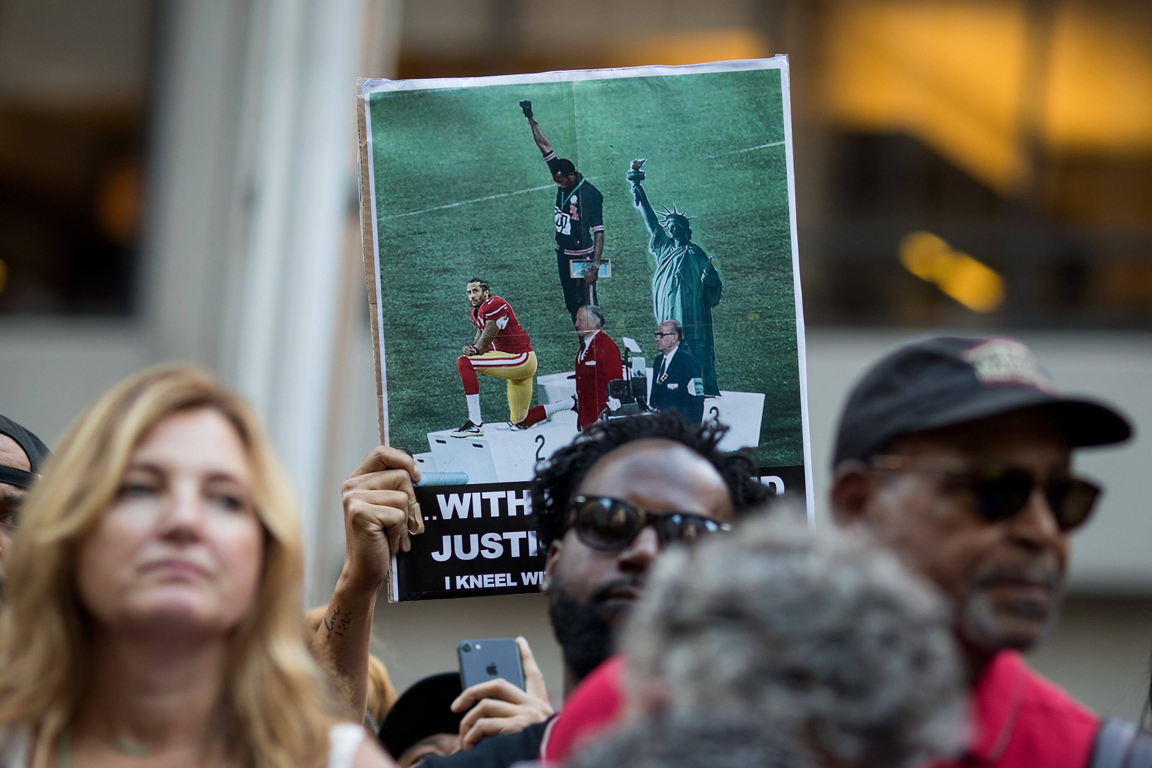 NEW YORK, NY - AUGUST 23: Activists rally in support of NFL quarterback Colin Kaepernick outside the offices of the National Football League on Park Avenue, August 23, 2017 in New York City. During the NFL season last year, Kaepernick caused controversy by kneeling during the National Anthem at games to protest racial oppression and police brutality. Kaepernick is currently a free agent and some critics and analysts claim NFL teams don't want to sign him due to his public display of his political beliefs. (Photo by Drew Angerer/Getty Images)