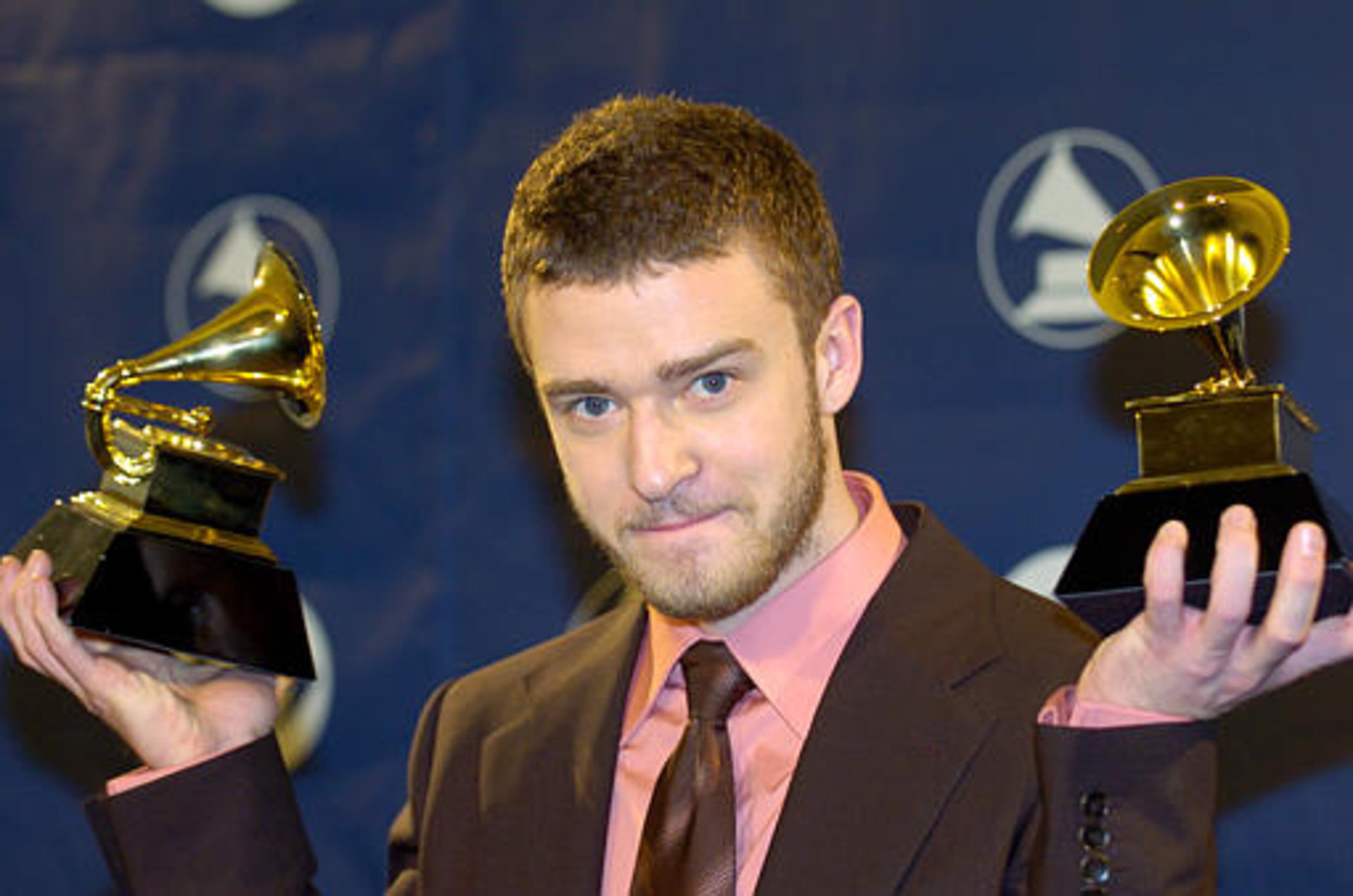 Justin Timberlake holds the awards he won for best male pop vocal performance and best pop vocal album at the 46th Annual Grammy Awards, Sunday, Feb. 8, 2004, in Los Angeles. (AP Photo/Mark J. Terrill)
