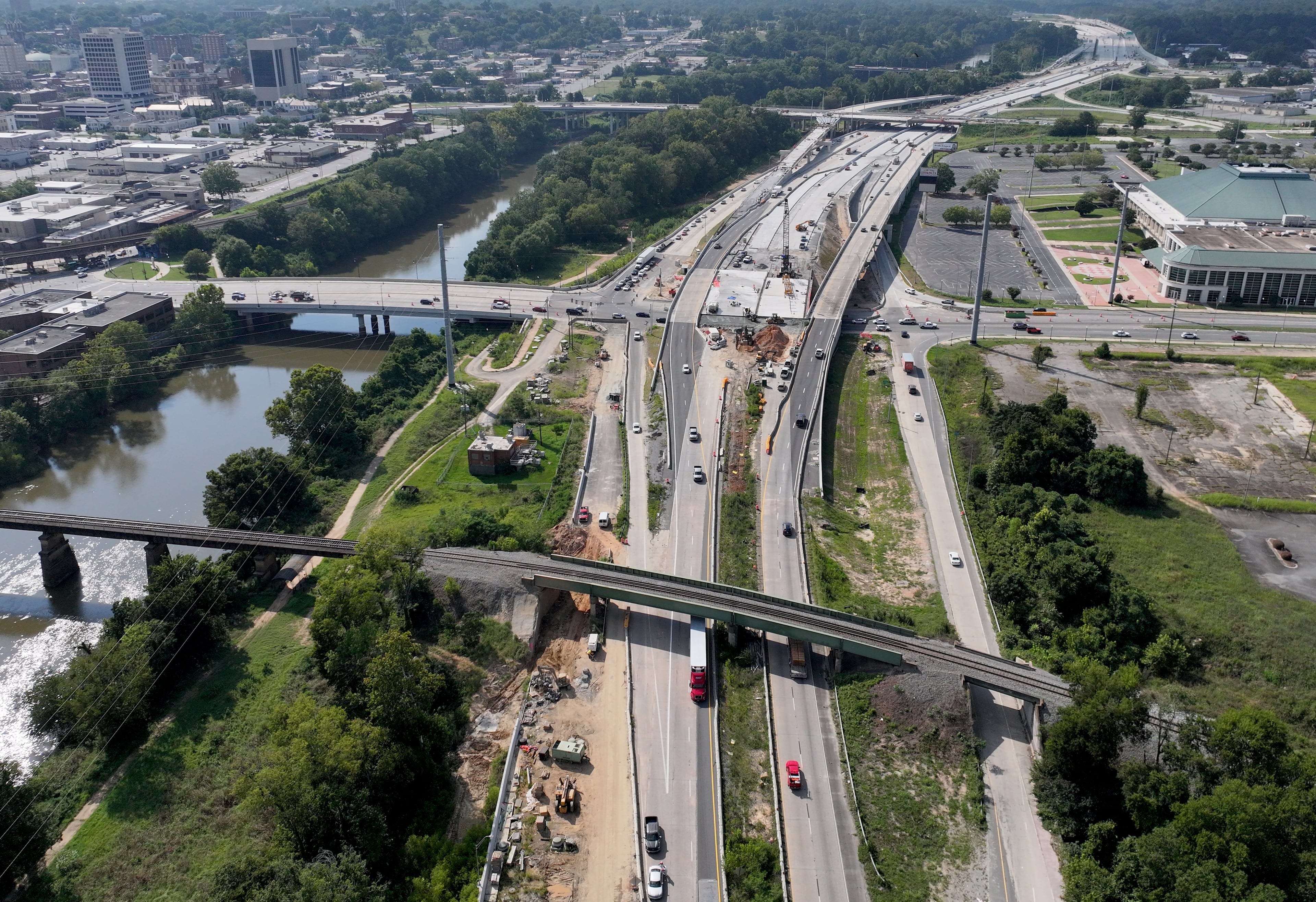 A view of an I-16 construction zone looking northwesterly up the Ocmulgee River. Downtown Macon, at left, sits near the junction of I-16 and I-75. The area where the two freeways meet is in the upper-right corner of the photograph. (Hyosub Shin / AJC)
