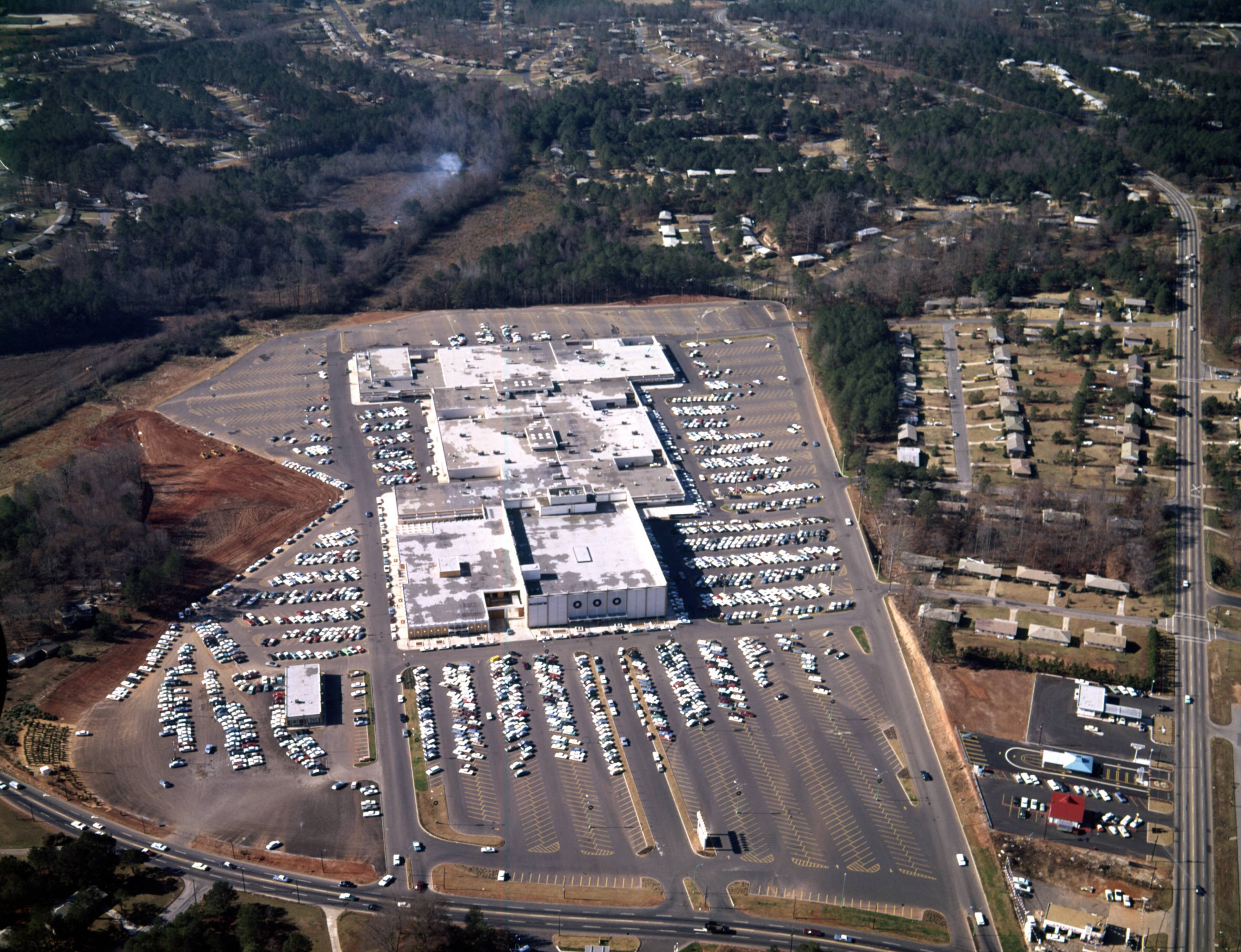 Aerial view of North DeKalb Mall and its surrounding parking lot, Atlanta, Georgia, December 21, 1965. Intersection of Lawrenceville Highway and North Druid Hills Road
