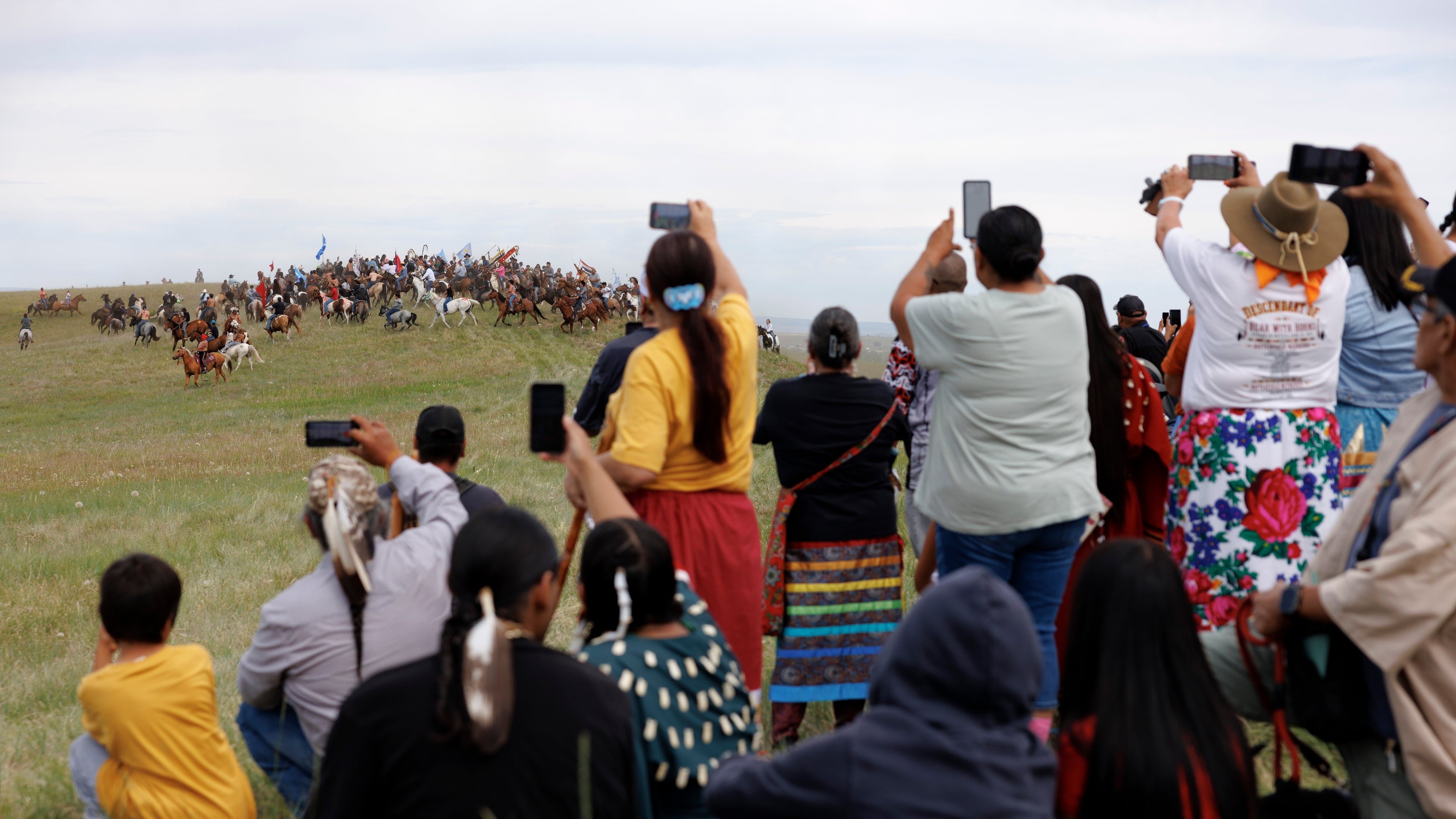 Spectators watch the charging event during festivities to commemorate the 150th anniversary of the Battle of the Little Bighorn in Crow Agency, Mont., on Thursday, June 25, 2026. (AP Photo/Tailyr Irvine)