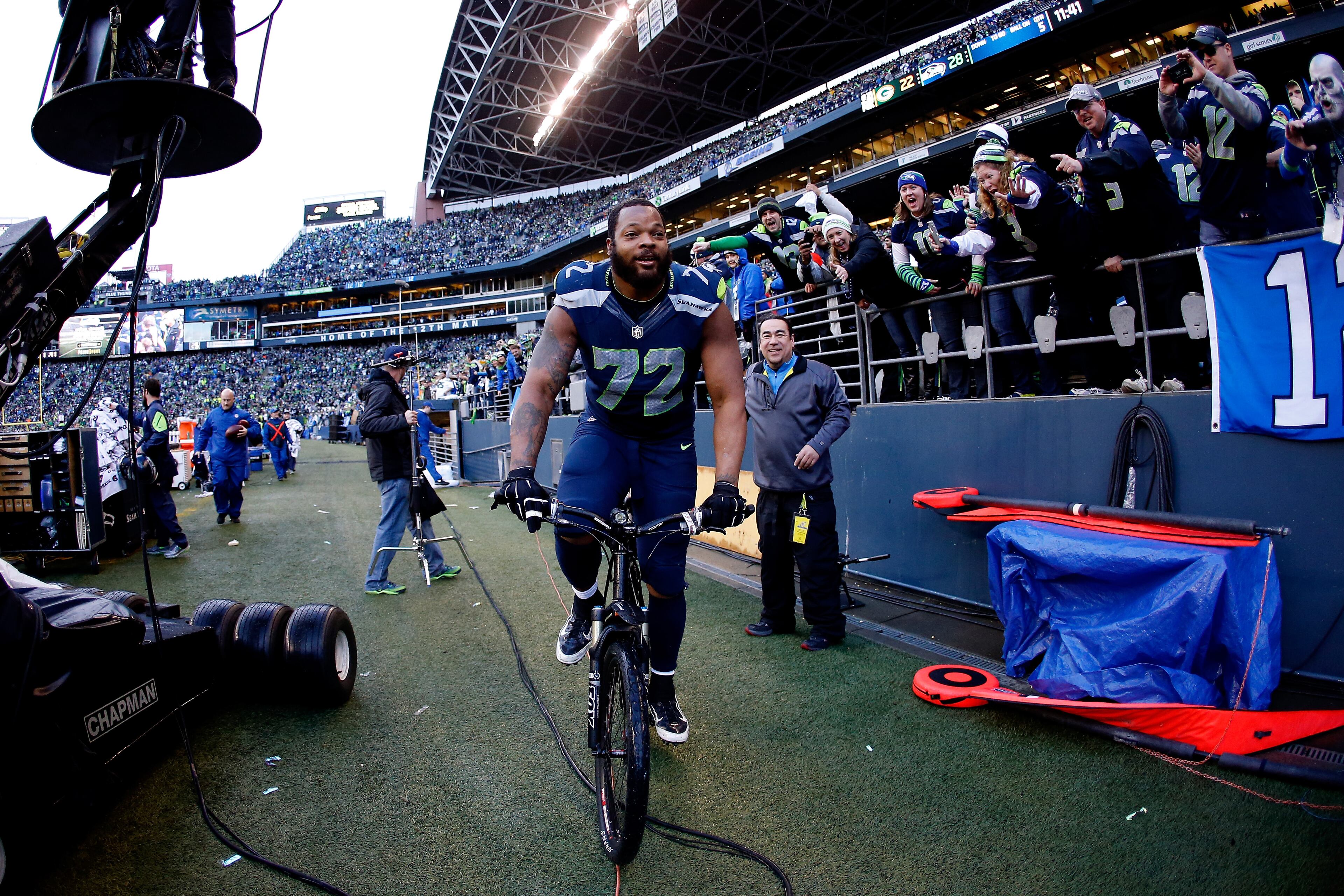 SEATTLE, WA - JANUARY 18: Michael Bennett #72 of the Seattle Seahawks rides a police bike after the Seahawks 28-22 overtime victory against the Green Bay Packers during the 2015 NFC Championship game at CenturyLink Field on January 18, 2015 in Seattle, Washington. (Photo by Otto Greule Jr/Getty Images)