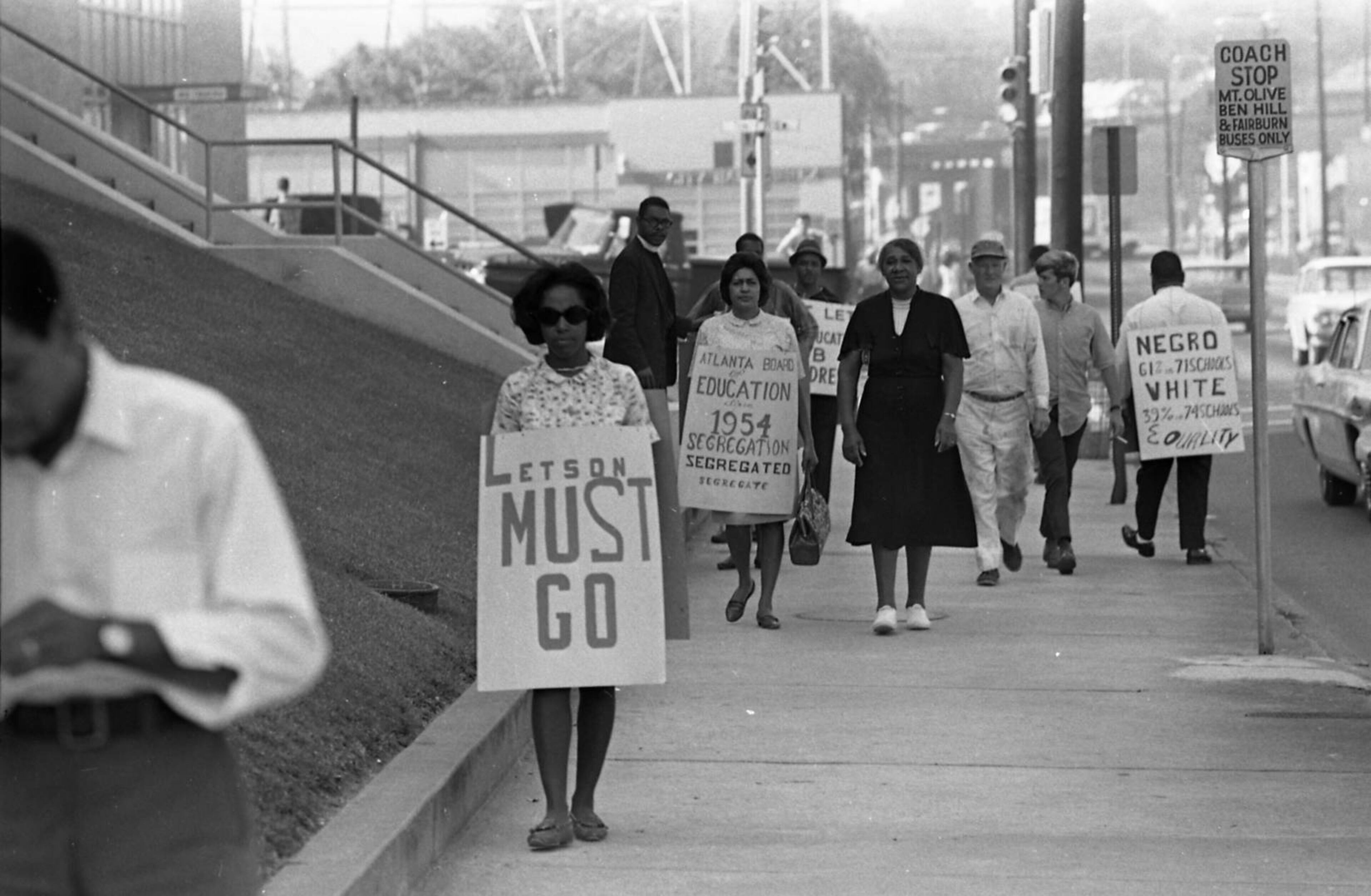 1967 -- African-American picketers protesting school segregation walk a line outside of the Atlanta Public Schools building. Some called for Board of Education Superintendent John W. Letson to be removed from office.