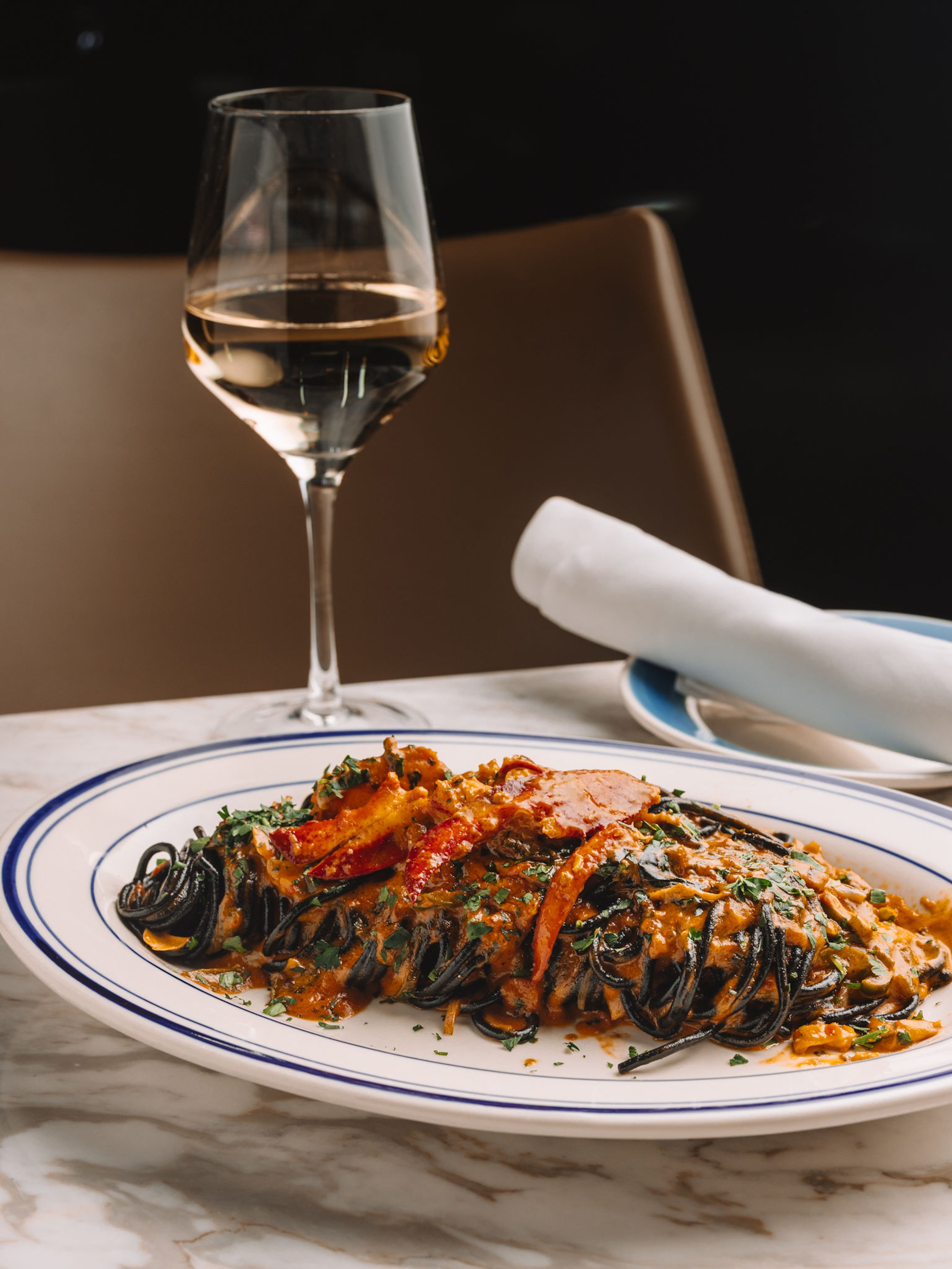Black spaghetti is served with a spicy, lip-smacking tomato brandy cream sauce and buttery pieces of poached lobster. (Courtesy of Rosso)