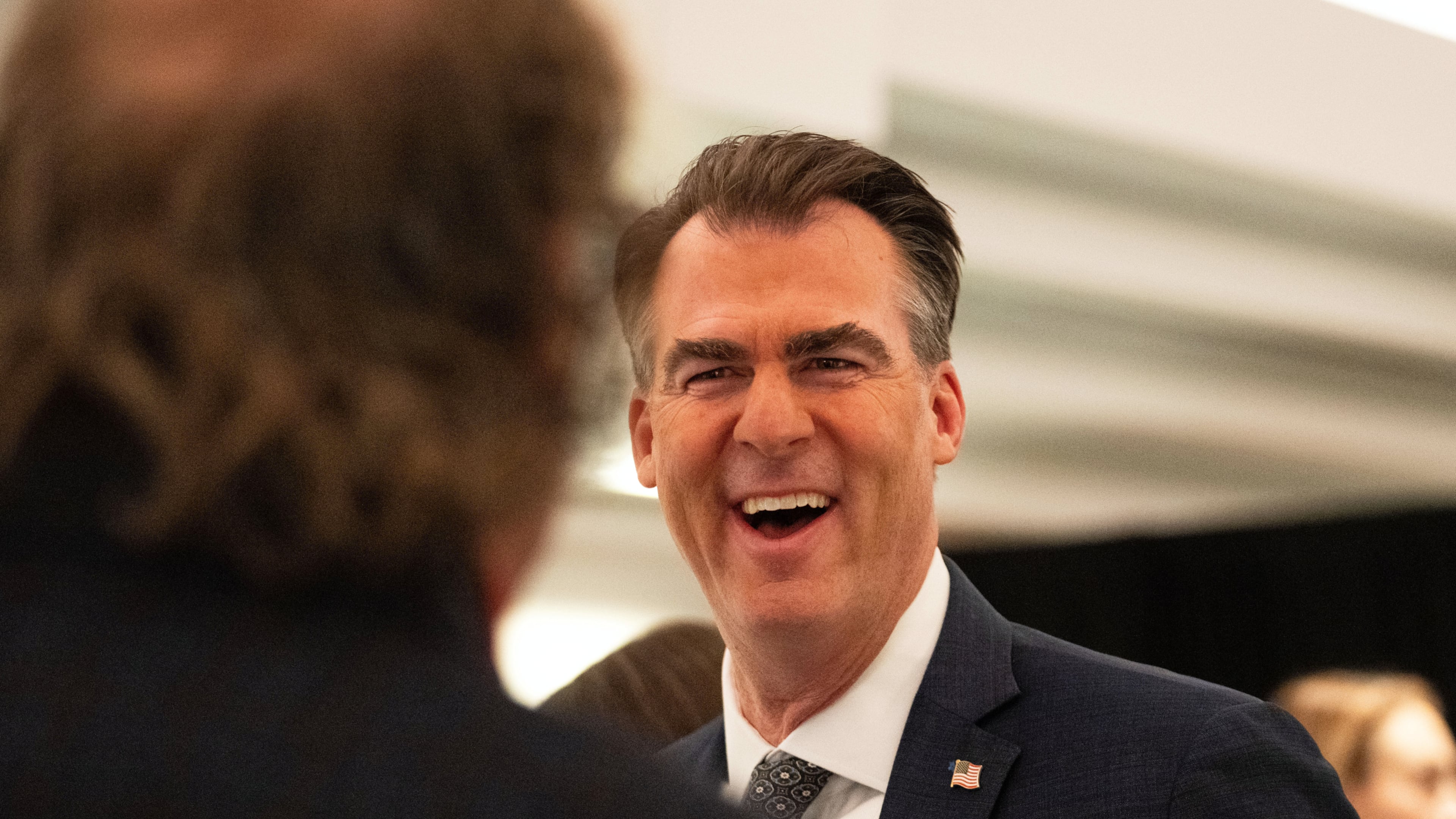 FILE - Oklahoma Gov. Kevin Stitt speaks with an individual following an event at the National Governors Association Winter Meeting, Feb. 19, 2026, in Washington. (AP Photo/Allison Robbert, File)