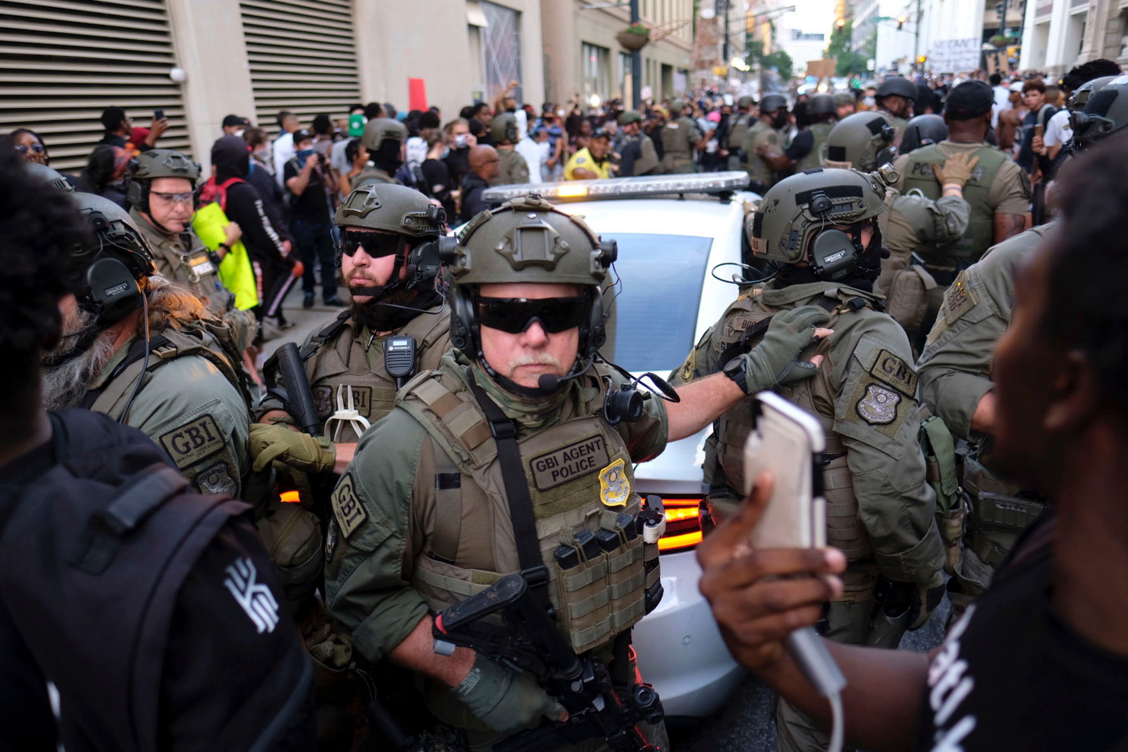 June 2, 2020 - Atlanta - Tense stand-off after homeland security officers took a protester into custody. They had to bring in a team of officers to extract the car. Could have been really bad, but the guy in yellow helped keep the crowd back a bit, and the officers did not escalate, even though they had to pull people out of the cars path Protestors in downtown Atlanta as protests continued for a fourth day. Protests over the death of George Floyd in Minneapolis police custody continued around the United States, as his case renewed anger about others involving African Americans, police and race relations. Ben Gray for the Atlanta Journal Constitution