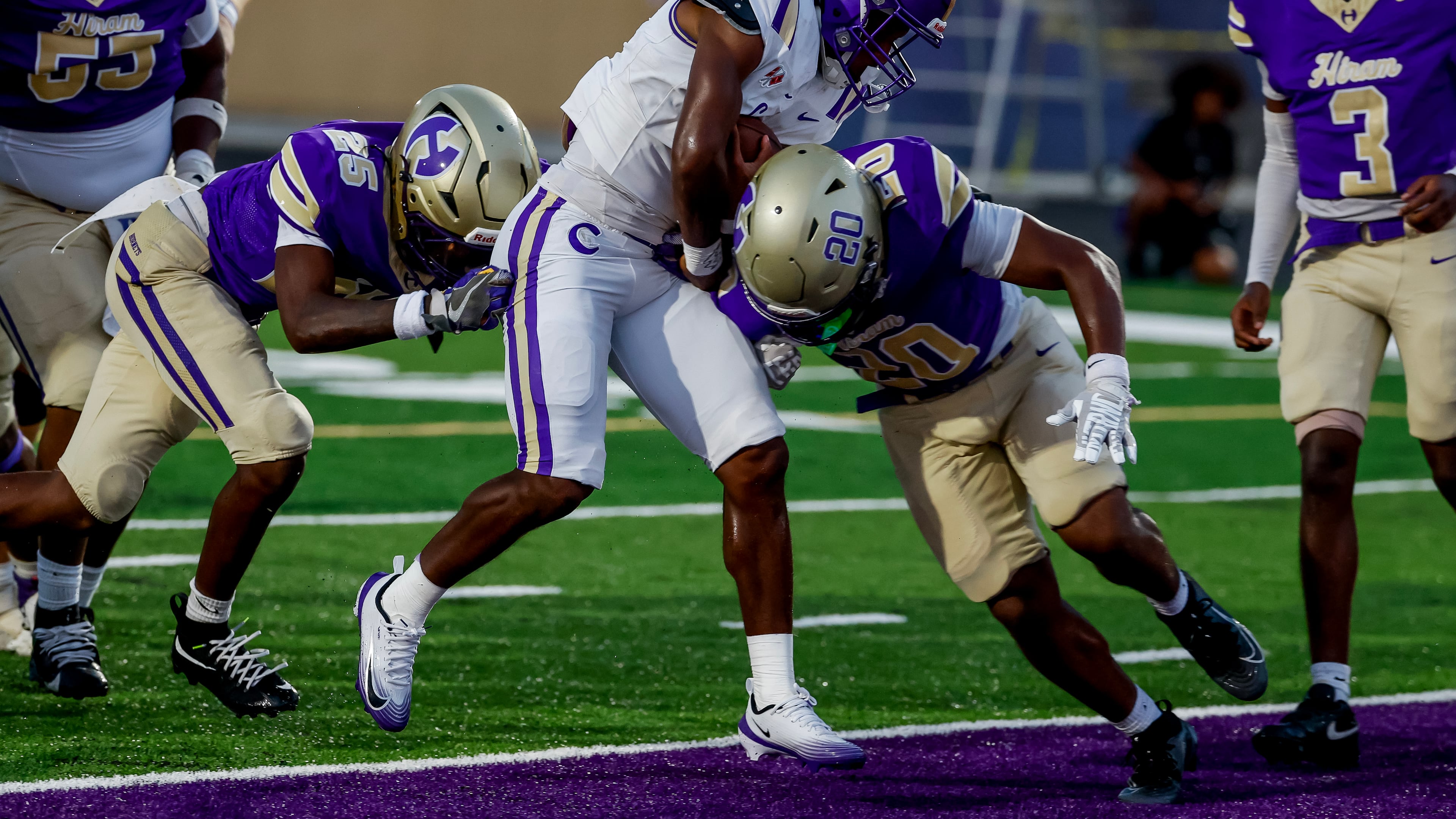 Cartersville's Tyon Coe (center) scores a first half touchdown against Hiram's Markens Felix (right) and Devin Giles in August. (Erik S. Lesser for the AJC)