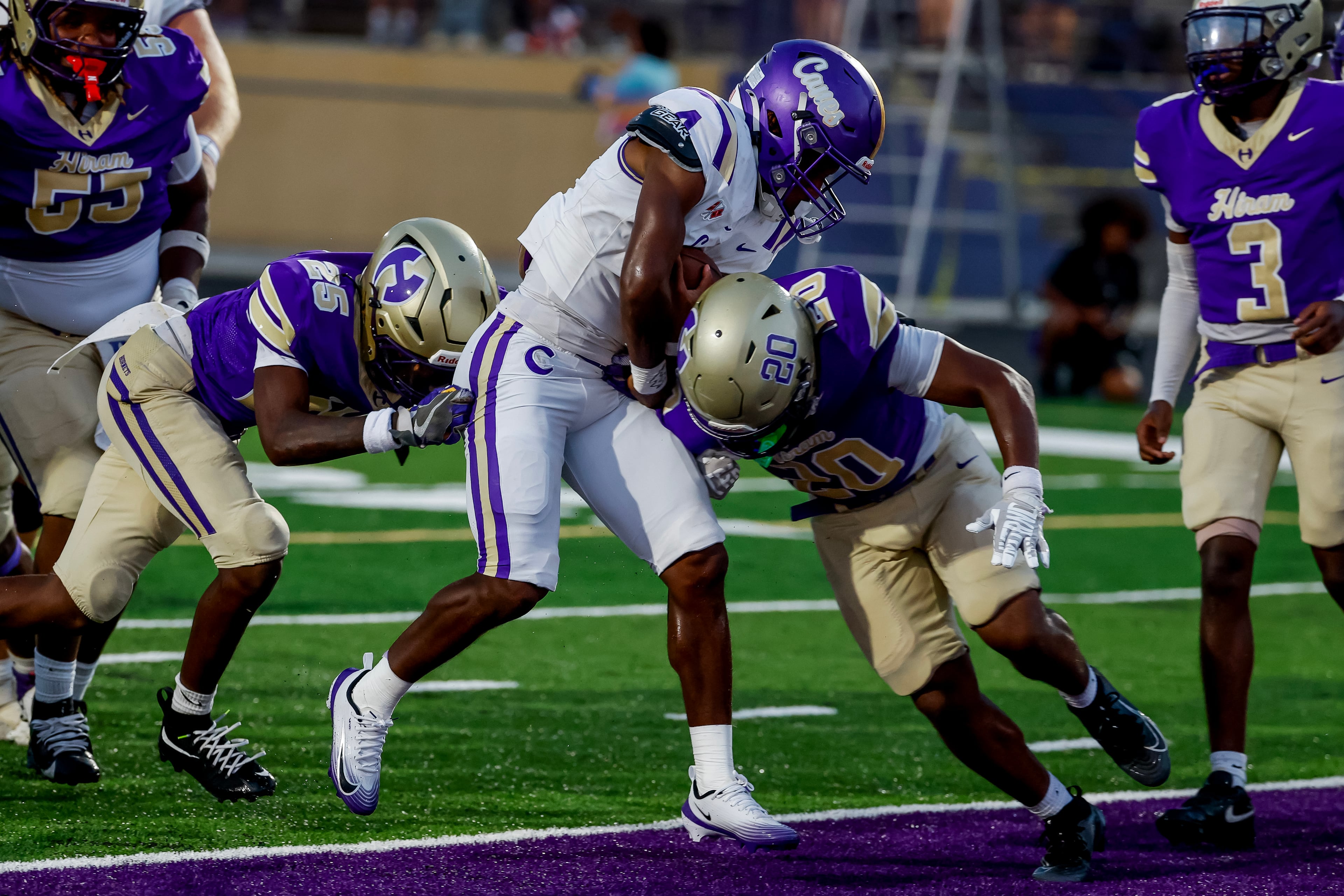 Cartersville running back Tyon Coe (center) scores a first half touchdown between Hiram defensive tackle Markens Felix (right) and outside linebacker Devin Giles on Friday, Aug. 21, 2026, in Hiram. (Erik S. Lesser for the AJC)