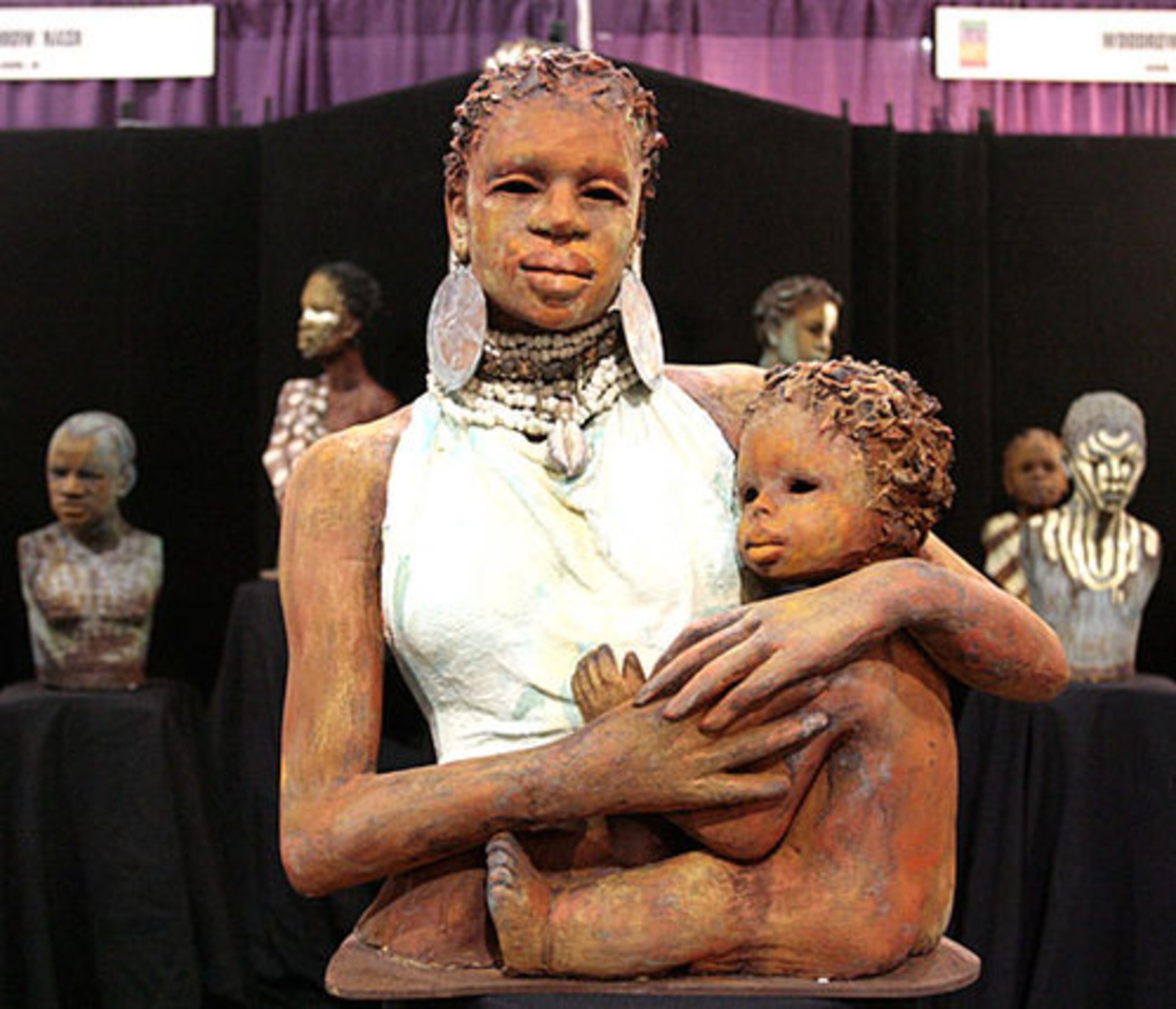 Clay sculpture by Woodrow Nash entitled "Almitra." Nash is an artist who travelled from Akron, Ohio, to attend the National Black Arts Festival. This artists and vendors display, one of several associated with the NBAF, was at the Georgia World Congress Center.