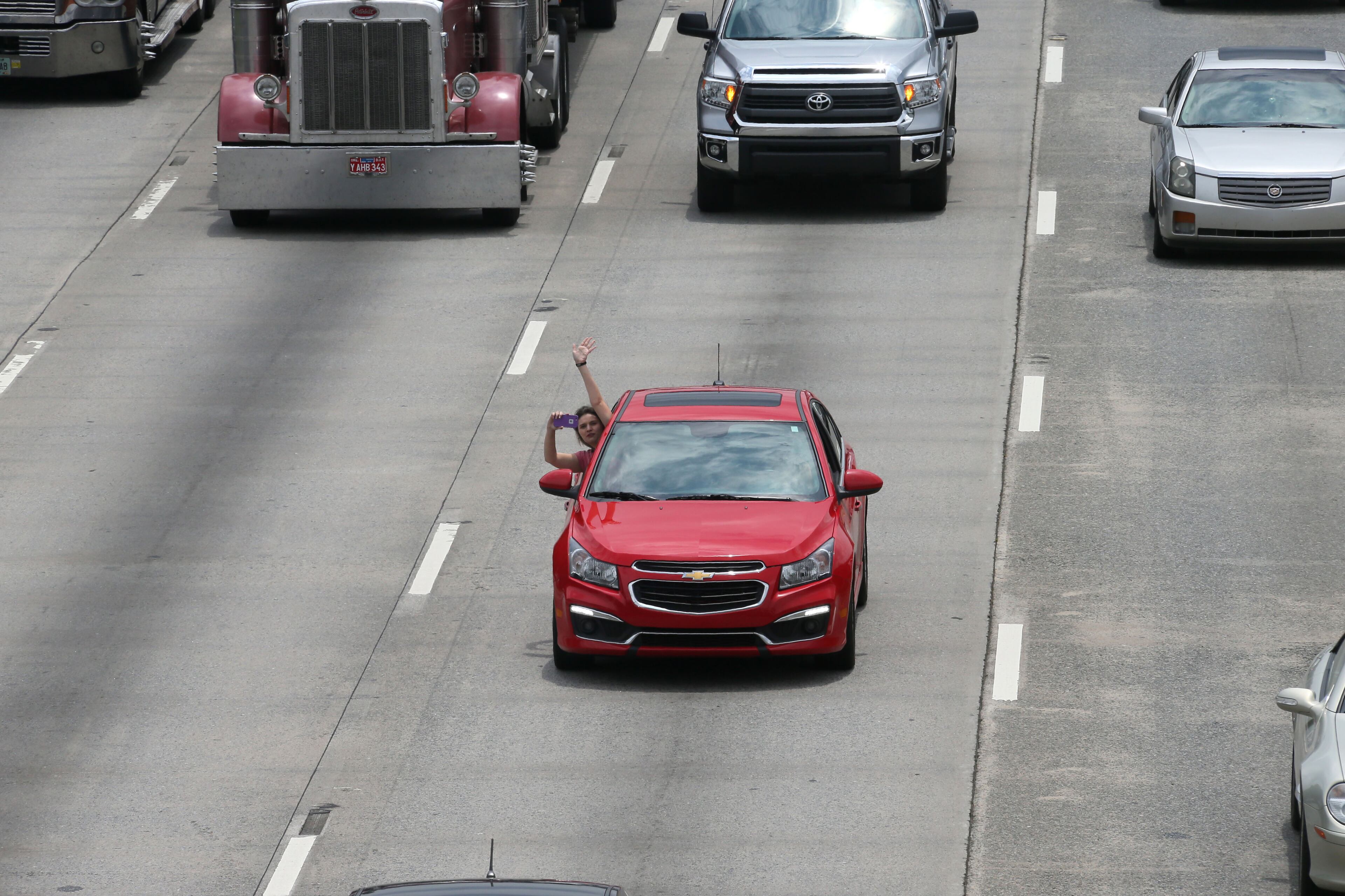Drivers honked their horns and waved as traffic built up before the overpass ahead of the motorcade. The body of Lance Cpl. Skip Wells was escorted via motorcade from Hartsfield-Jackson International Airport along Interstate 75 to Cobb County. The Marietta Police Department shut down a portion of the Canton Road Connector Bridge over Interstate 75, so that the City and citizens could pay their respects to Lance Corporal Wells as his procession passed below. BOB ANDRES / BANDRES@AJC.COM