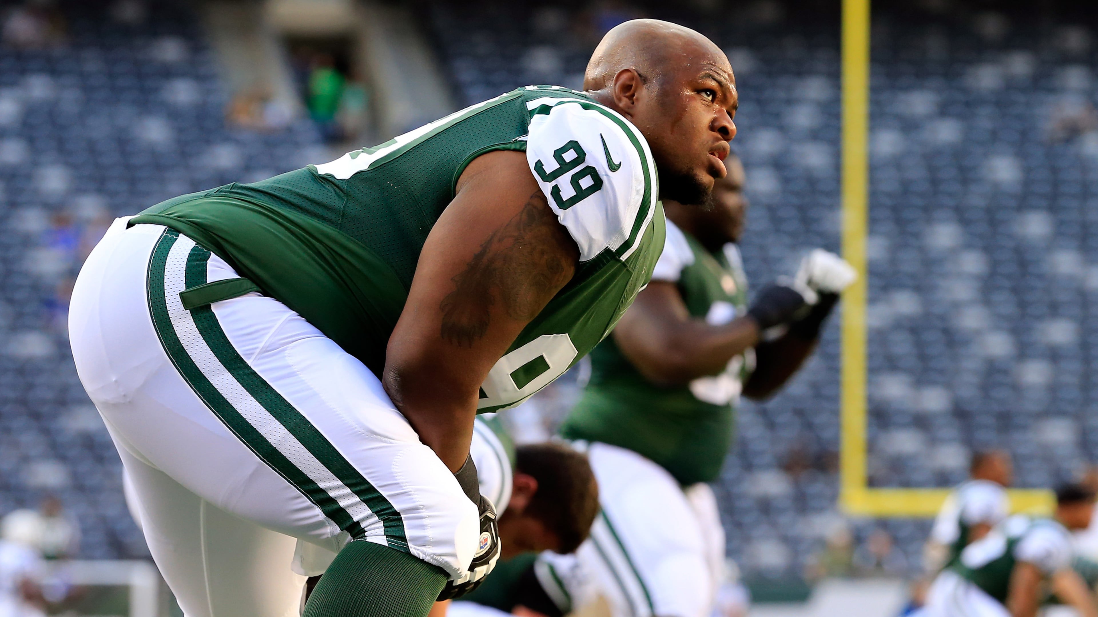 EAST RUTHERFORD, NJ - AUGUST 07: Defensive tackle T.J. Barnes #99 of the New York Jets stretches prior to a preseason game against the Indianapolis Colts at MetLife Stadium on August 7, 2014 in East Rutherford, New Jersey. (Photo by Alex Trautwig/Getty Images)