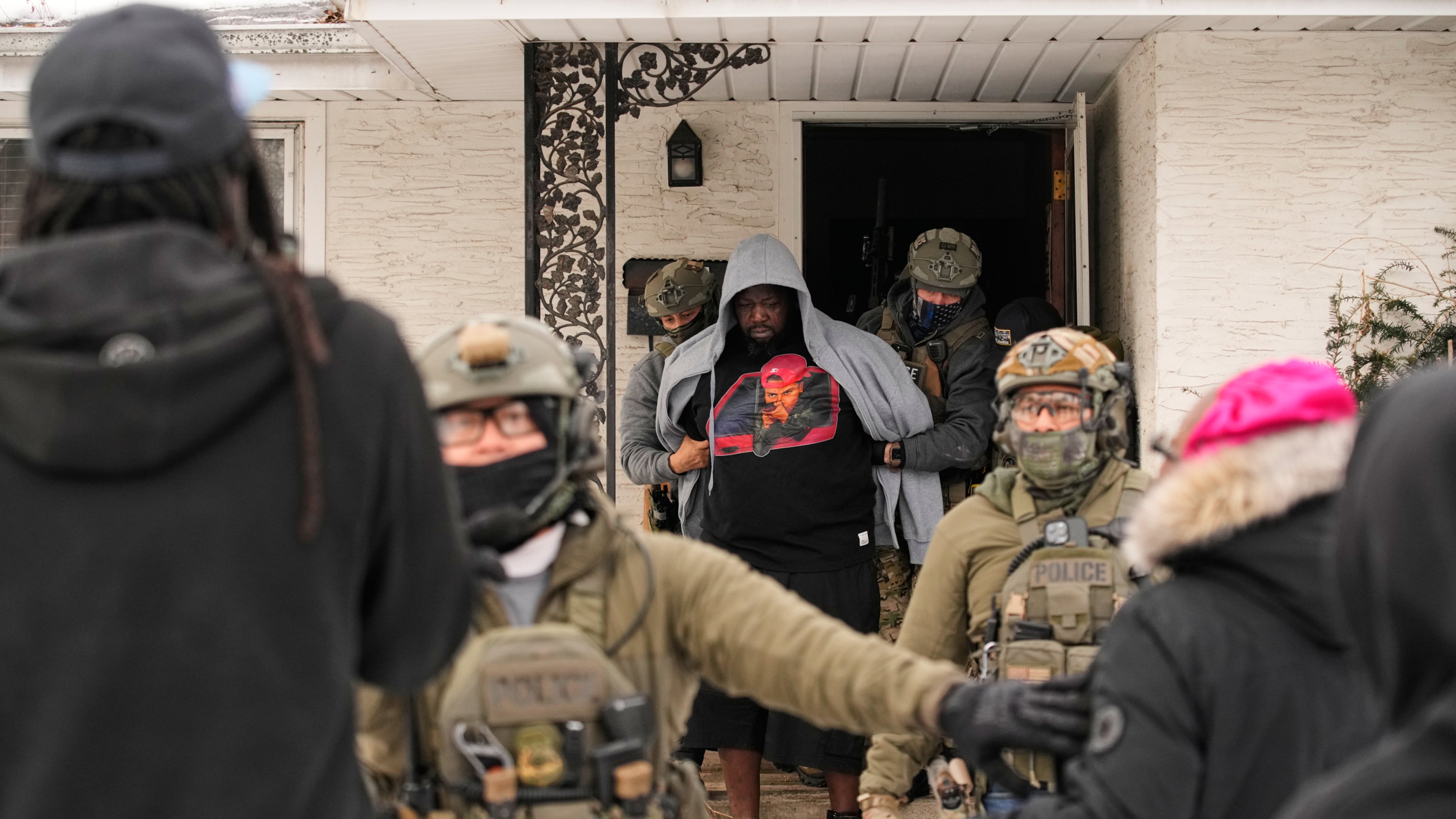 ADDS IDENTIFICATION: Garrison Gibson is arrested by federal immigration officers Sunday, Jan. 11, 2026, in Minneapolis. (AP Photo/John Locher)