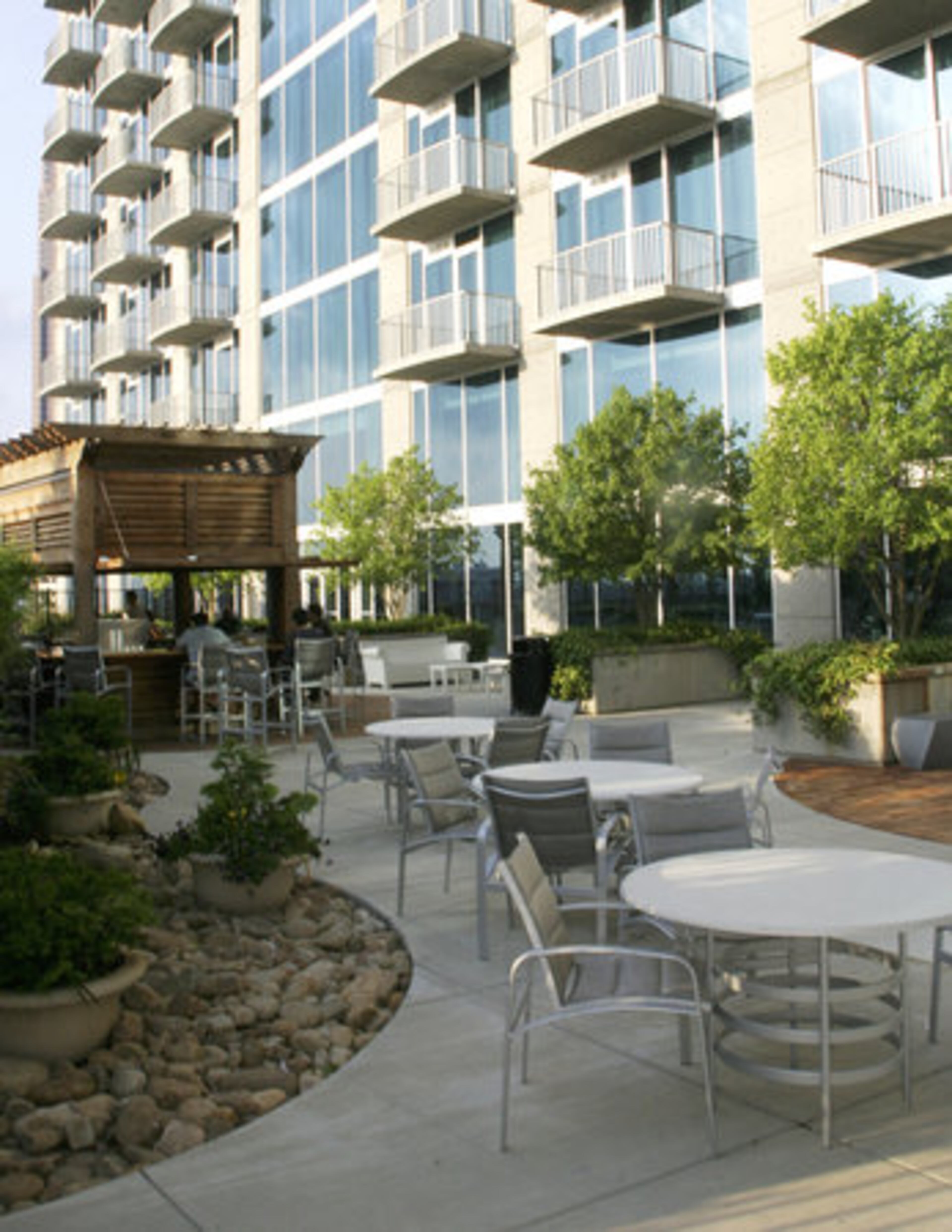 Residents of the high-rise condo Twelve at Centennial Park don't have to travel far to indulge in happy-hour cocktails, because there's a tiki bar in the courtyard near the pool.