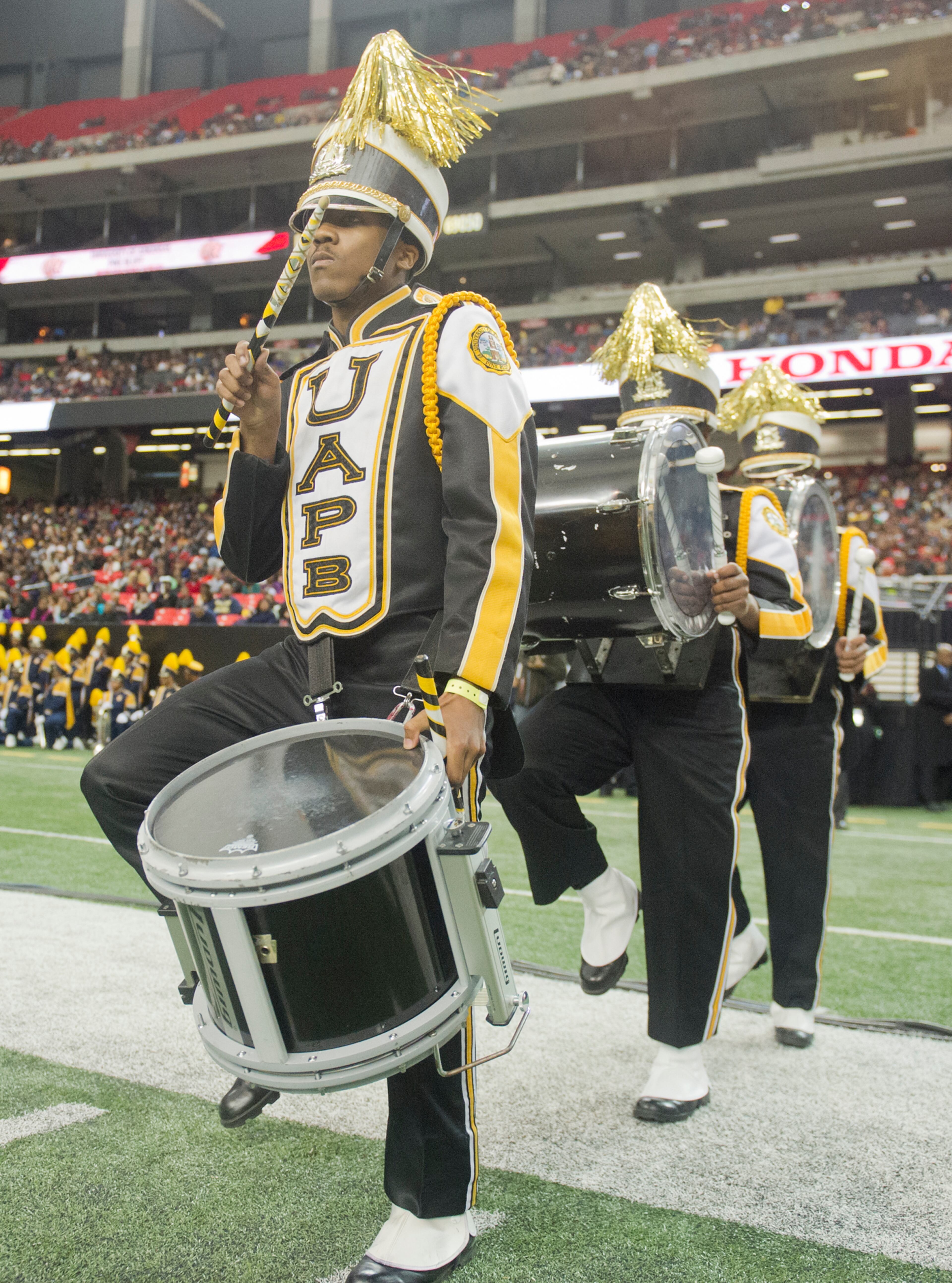 University of Arkansas at Pine Bluff's Tyreek Thompson (left) plays the snare drum as he marches onto the field during the 2014 Honda Battle of the Bands at the Georgia Dome in Atlanta on Jan. 25, 2014.