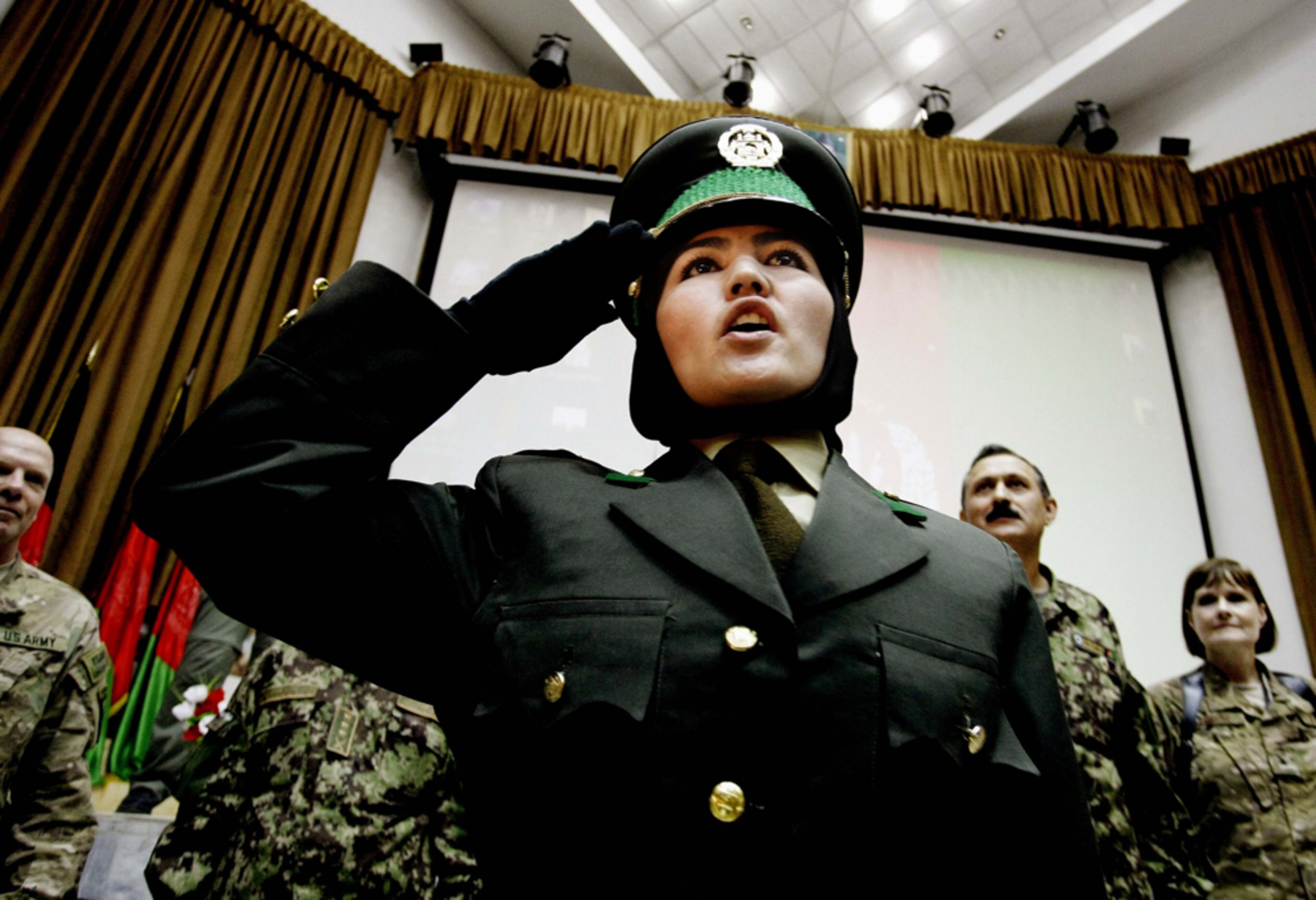 READY FOR DUTY--An Afghan military officer salutes after receiving her certification, unseen, during a graduation ceremony at the Kabul Military Training Center in Kabul, Afghanistan, Thursday, Sept. 13, 2012. The process of taking over security from over 130,000-strong NATO-led ISAF forces by Afghan troops would be completed by the end of 2014 when Afghanistan will take over the full leadership of its own security duties from US and NATO forces.