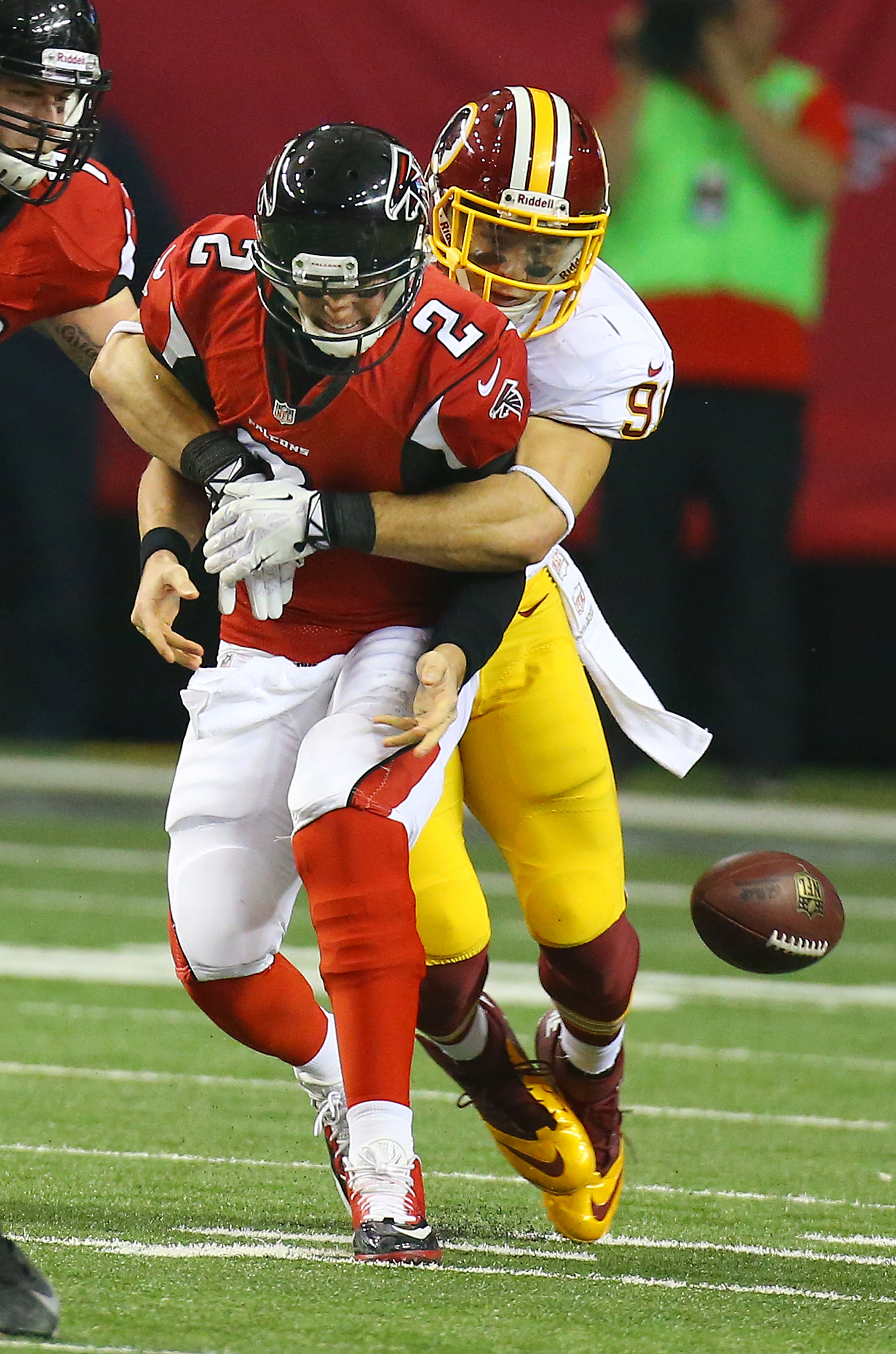 Falcons quarterback Matt Ryan fumbles the ball away to the Redskins as linebacker Ryan Kerrigan strips the ball away during 1st half action in a NFL football game on Sunday, Dec. 15, 2013, in Atlanta.