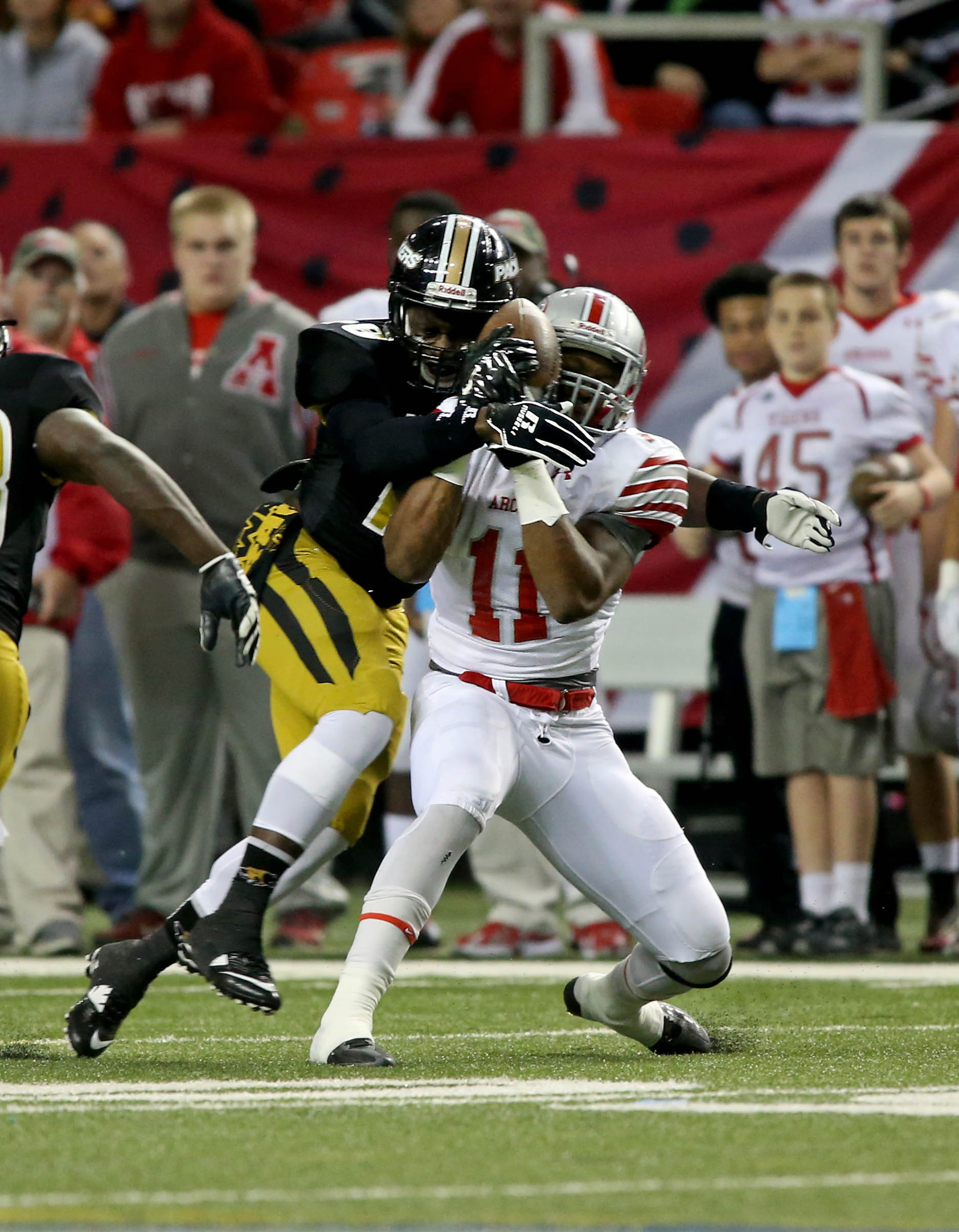 Colquitt County defensive back Javarious Madison (18) tackles Archer wide receiver Kyle Davis (11) after a reception in the first half of the Class AAAAAA state high school football championship at the Georgia Dome Saturday in Atlanta, Ga., December 13, 2014.