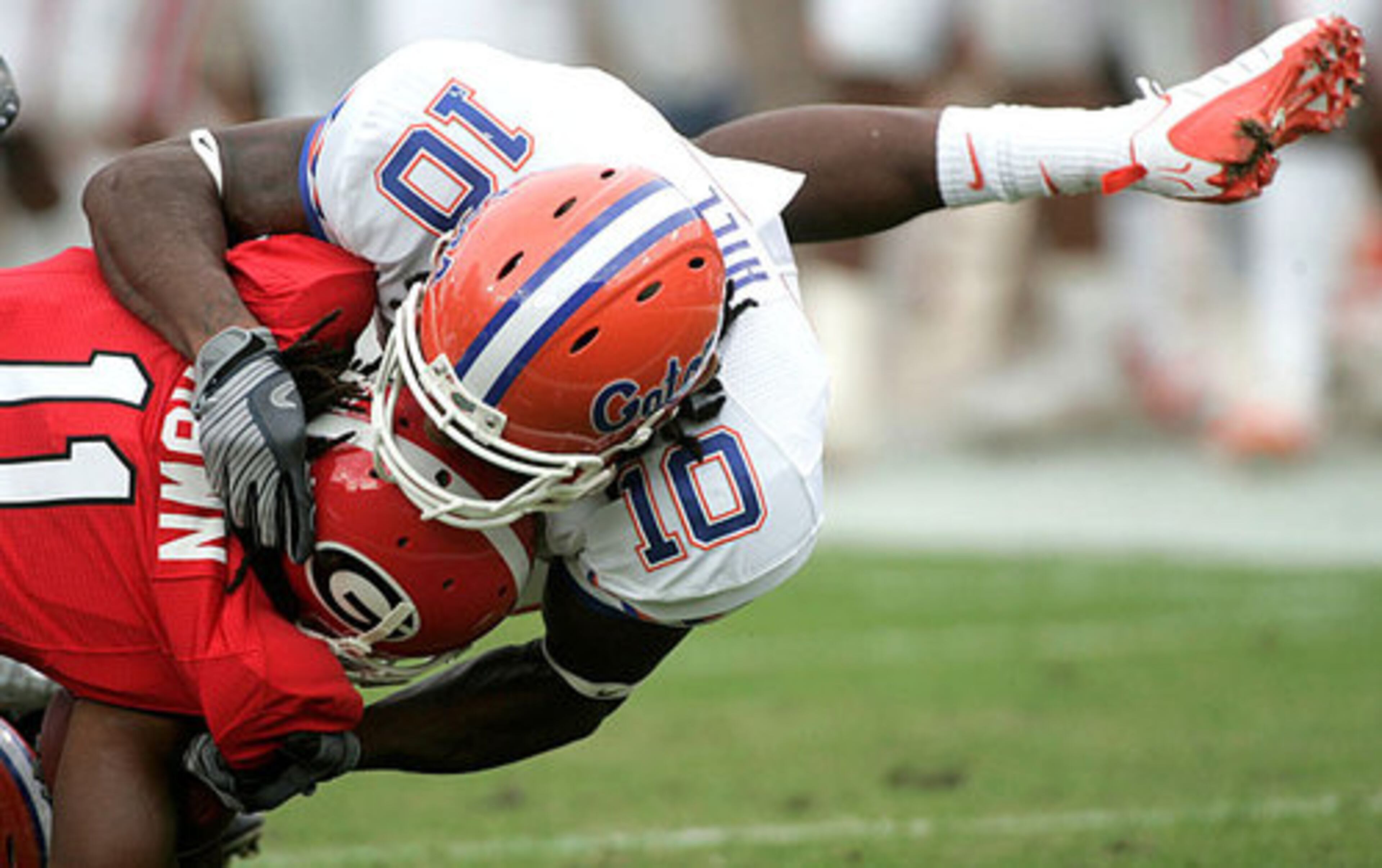 Florida safety Will Hill, right, tackles Georgia's Ramarcus Brown during a first-quarter kick-off return.