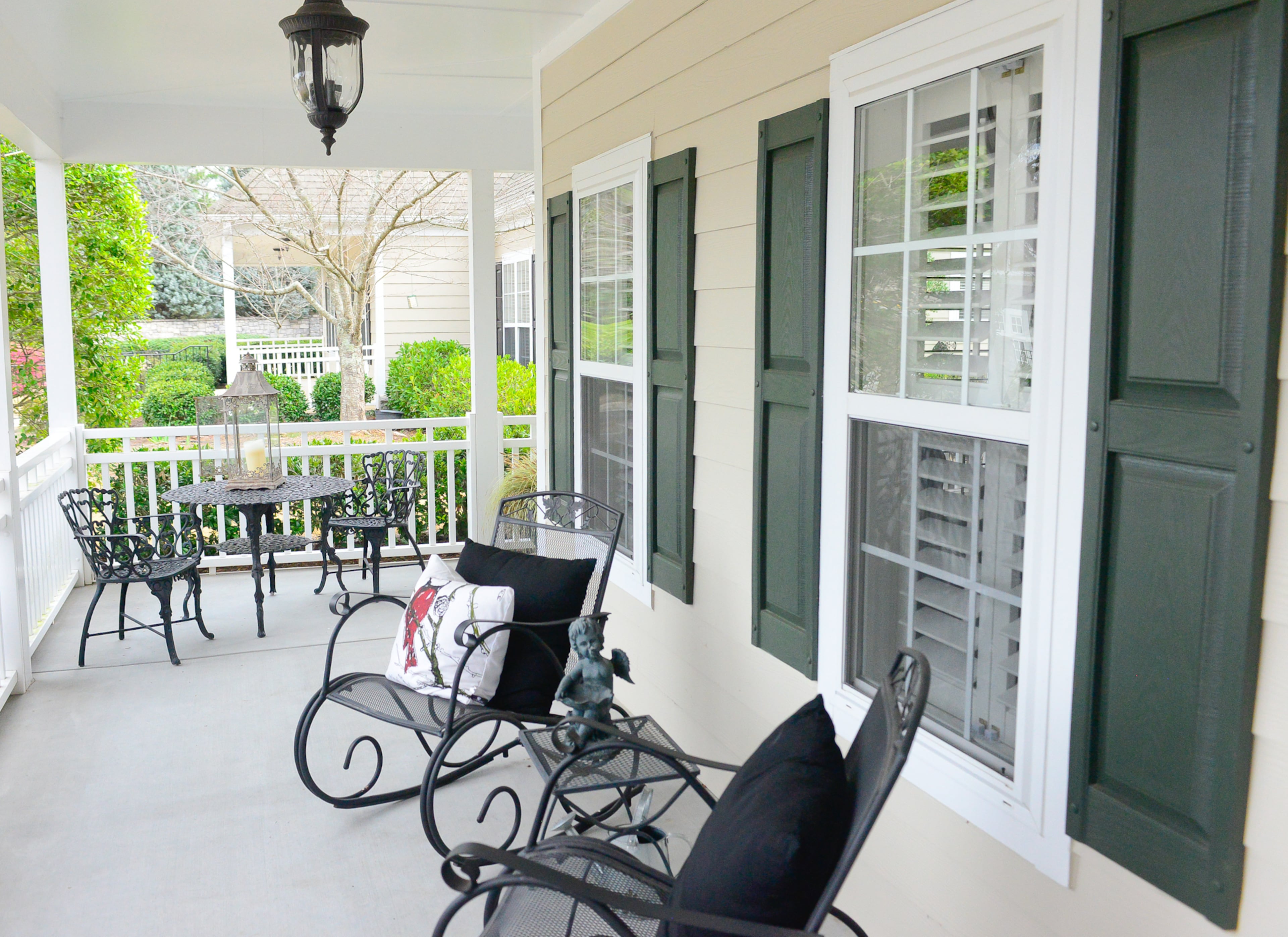 One of Linda’s favorite architectural elements is the wraparound porch, where she likes to sit when it rains. Rocking chairs, like those Linda saw on a visit to Gibbs Gardens, beckon the family and guests to linger on the front porch. The bistro table set, a purchase Linda and her husband made on a trip to Hilton Head, provides a place to sit with a cup of coffee or a book.