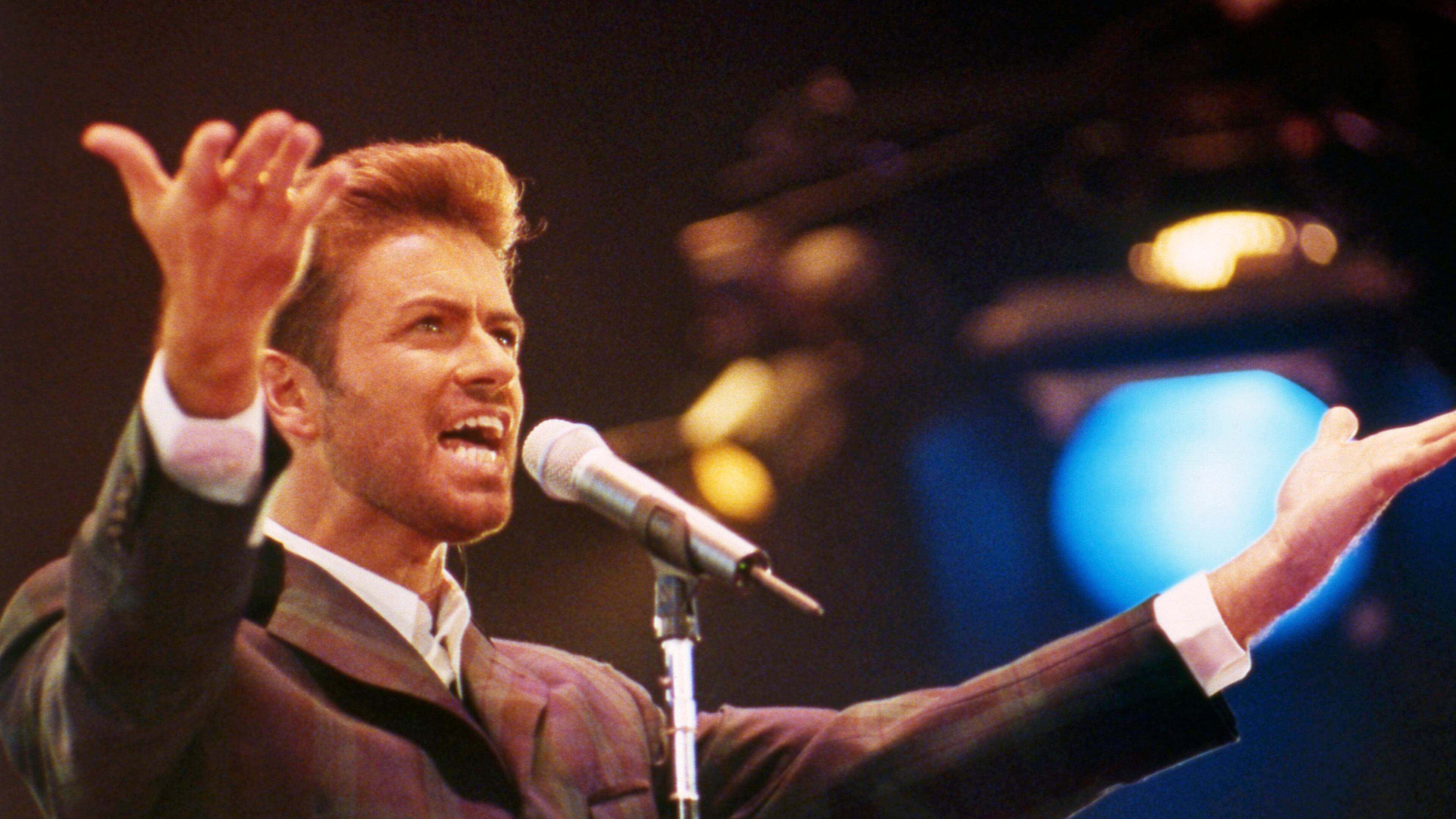 FILE - In this Dec. 2, 1993 file photo, George Michael performs at "Concert of Hope" to mark World AIDS Day at London's Wembley Arena. According to a publicist on Sunday, Dec. 25, 2016, the singer has died at the age of 53. (AP Photo/Gill Allen)